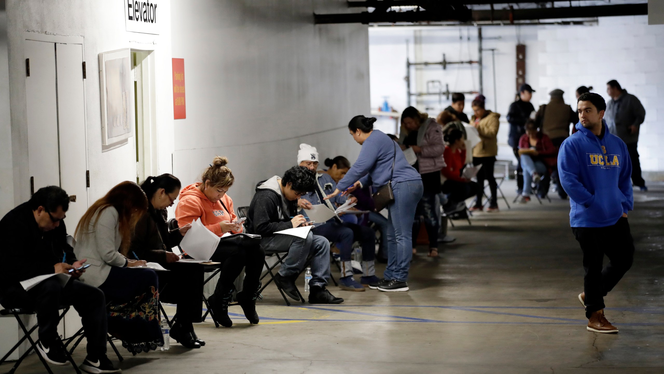 In this March 13, 2020 file photo, unionized hospitality workers wait in line in a basement garage to apply for unemployment benefits at the Hospitality Training Academy in Los Angeles. California's unemployment rate continued to climb in May, reaching 16.3% as businesses continued to lay people off because of a state-at-home order aimed at slowing the spread of the coronavirus that has wrecked the state's economy. (AP Photo/Marcio Jose Sanchez, File)