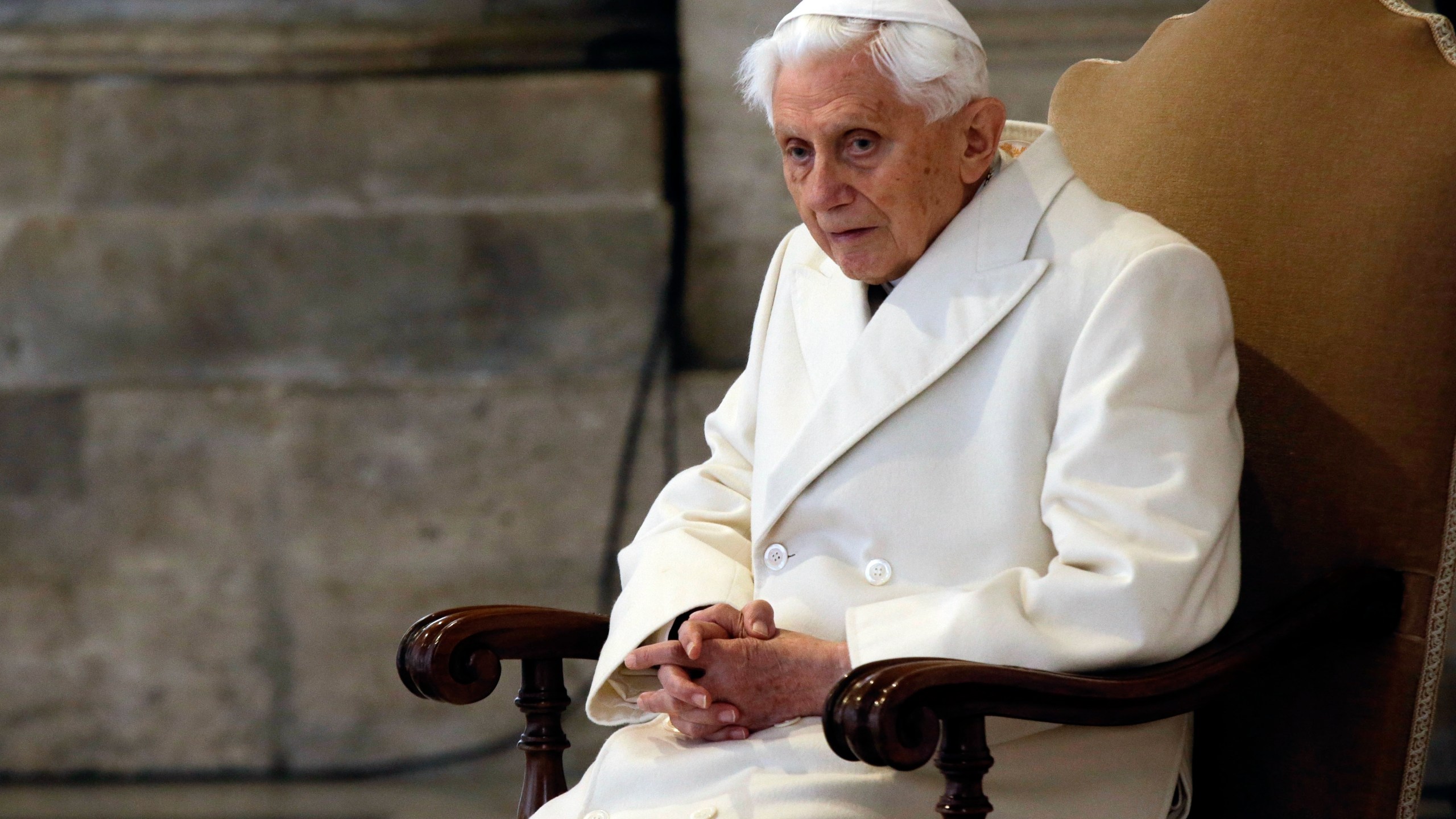 In this Tuesday, Dec. 8, 2015. filer, Pope Emeritus Benedict XVI attends a Mass prior to the opening of the Holy Door of St. Peter's Basilica, formally starting the Jubilee of Mercy, at the Vatican. (AP Photo/Gregorio Borgia, File)