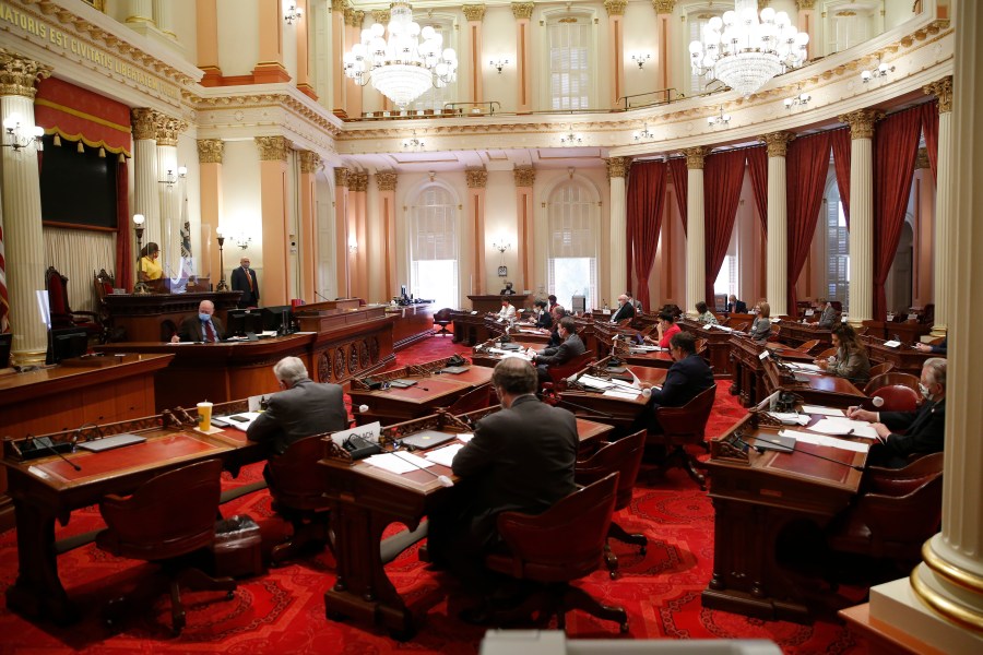 In this May 28, 2020, file photo, lawmakers wear face masks during a budget committee hearing in the Senate in Sacramento. (AP Photo/Rich Pedroncelli, File)