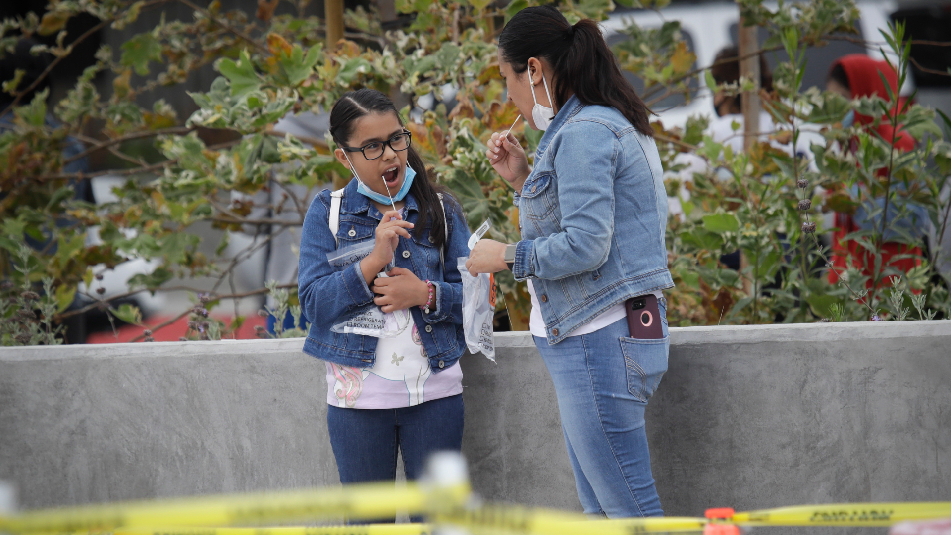 A woman and girl take a coronavirus test together in Los Angeles on July 22, 2020. (Marcio Jose Sanchez / Associated Press)