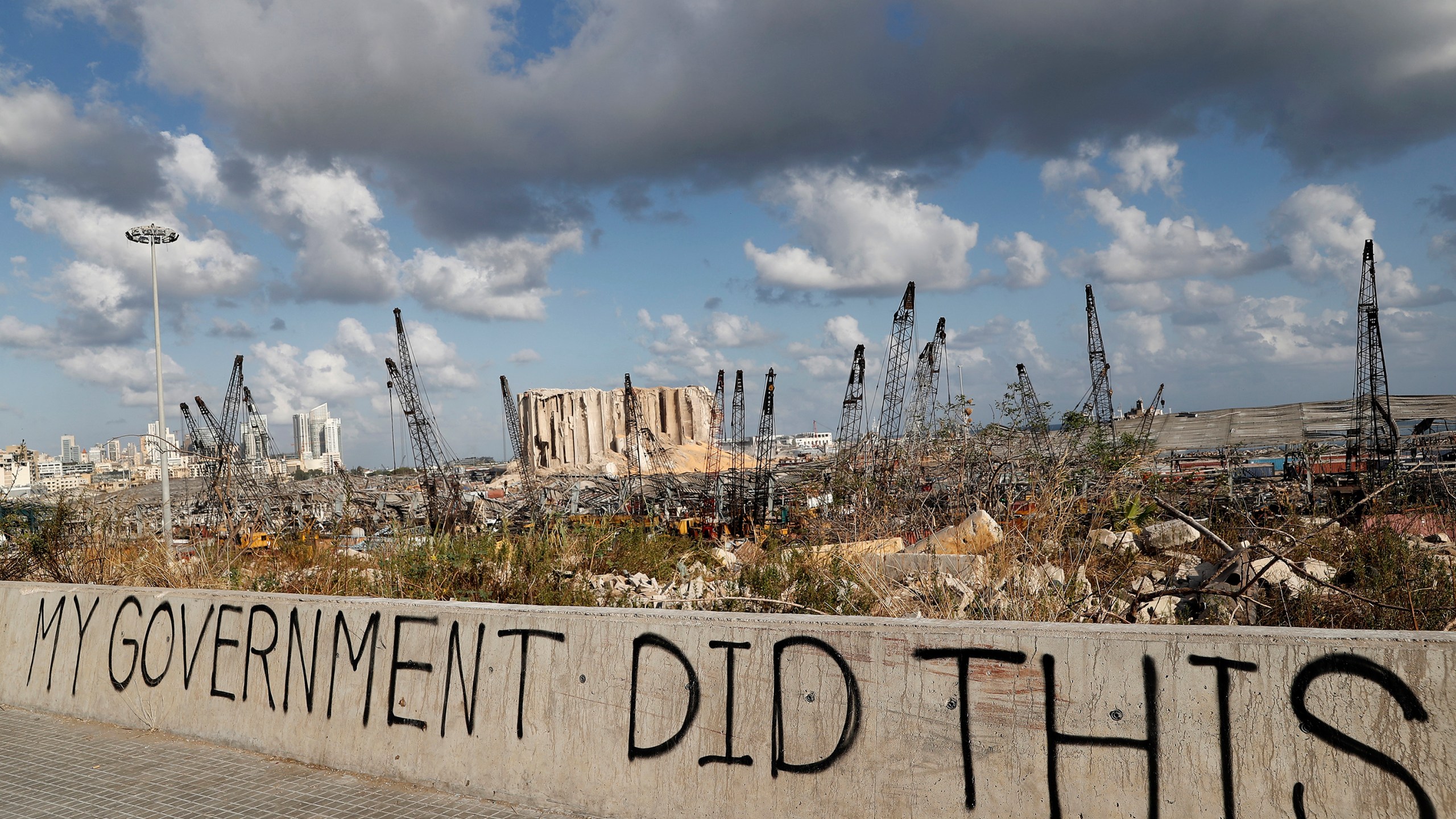 Words are written by Lebanese citizens in front of the scene of the explosion that hit the seaport of Beirut, Lebanon, Sunday, Aug. 9, 2020. (AP Photo/Hussein Malla)