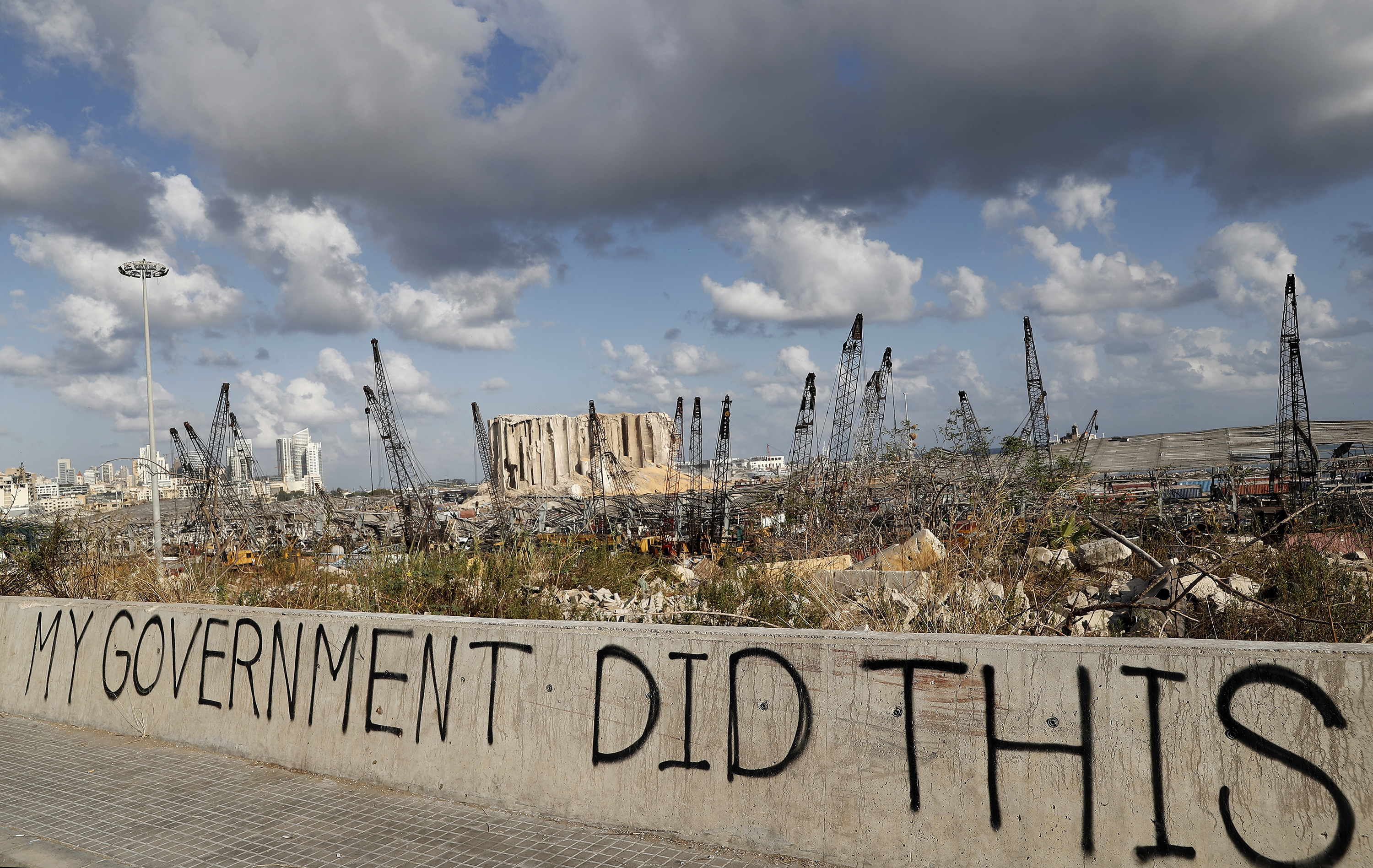 Words are written by Lebanese citizens in front of the scene of the explosion that hit the seaport of Beirut, Lebanon, Sunday, Aug. 9, 2020. (AP Photo/Hussein Malla)