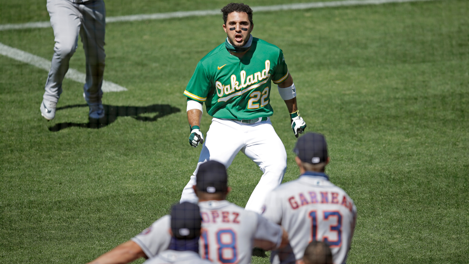 Oakland Athletics' Ramon Laureano charges the Houston Astros dugout after being hit by a pitch thrown by Humberto Castellanos in the seventh inning of a baseball game on Aug. 9, 2020, in Oakland. (Ben Margot / Associated Press)