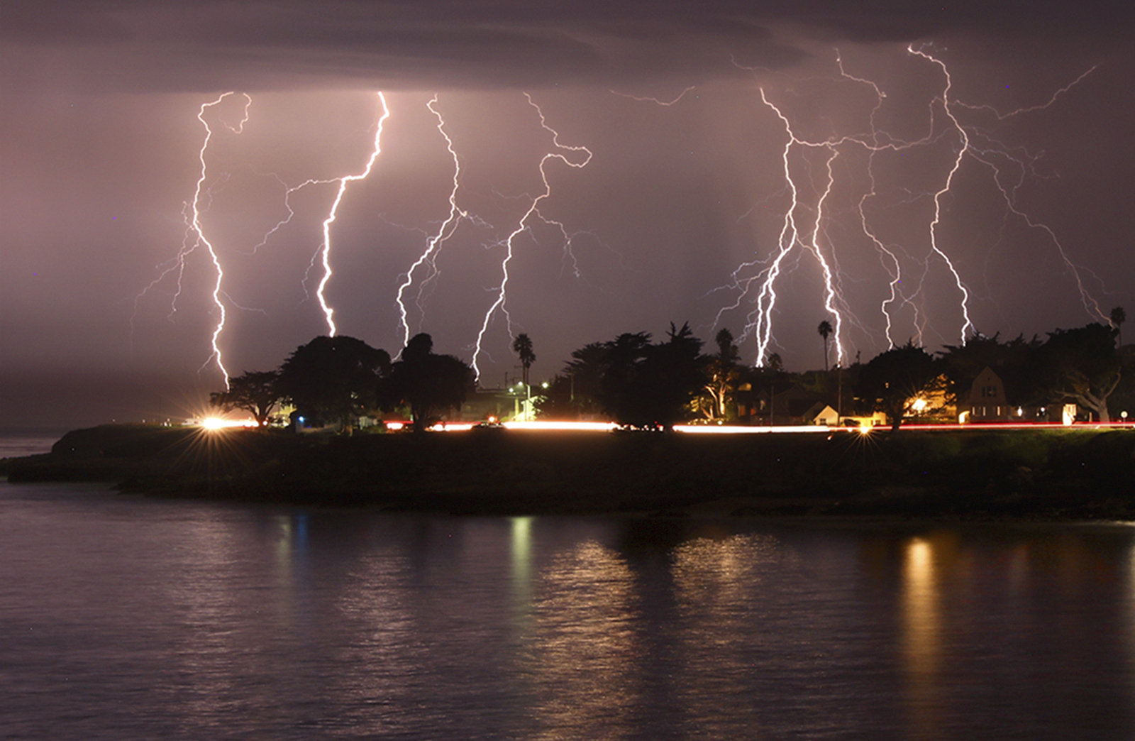 A rare lightning storm crackles over Mitchell's Cove in Santa Cruz, California around 3 a.m. Sunday morning August 16, 2020. (Shmuel Thaler/The Santa Cruz Sentinel via AP)