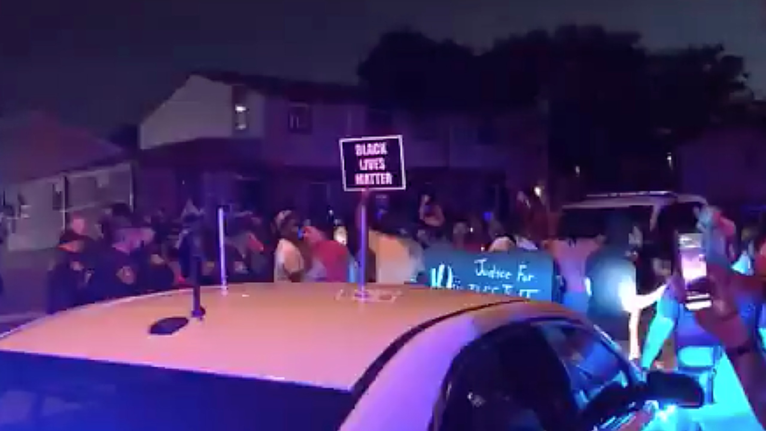 In this image made from video, protesters gather near the site of a police shooting, Sunday, Aug. 23 in Kenosha, (WDJT-TV via AP)