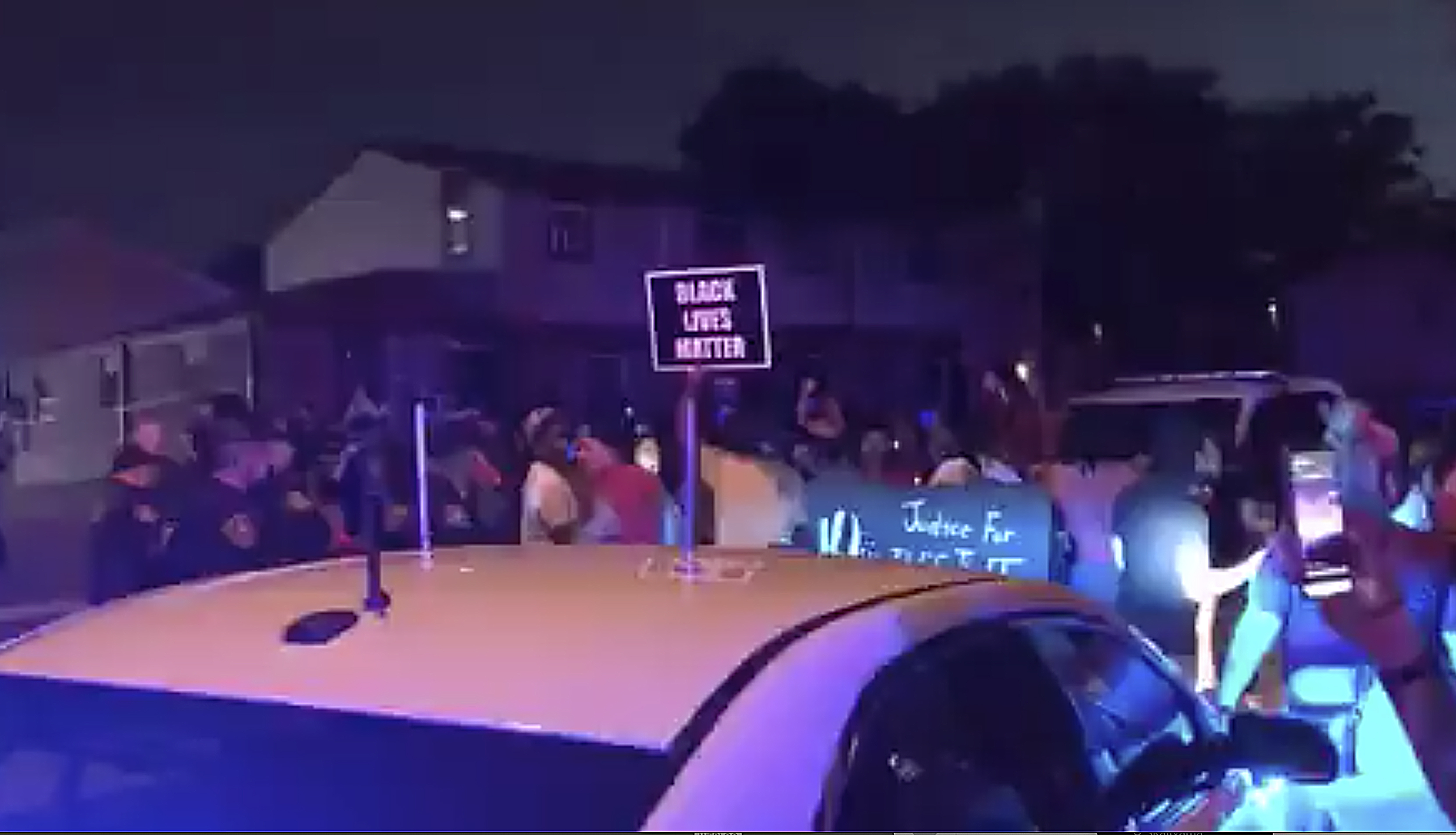 In this image made from video, protesters gather near the site of a police shooting, Sunday, Aug. 23 in Kenosha, (WDJT-TV via AP)