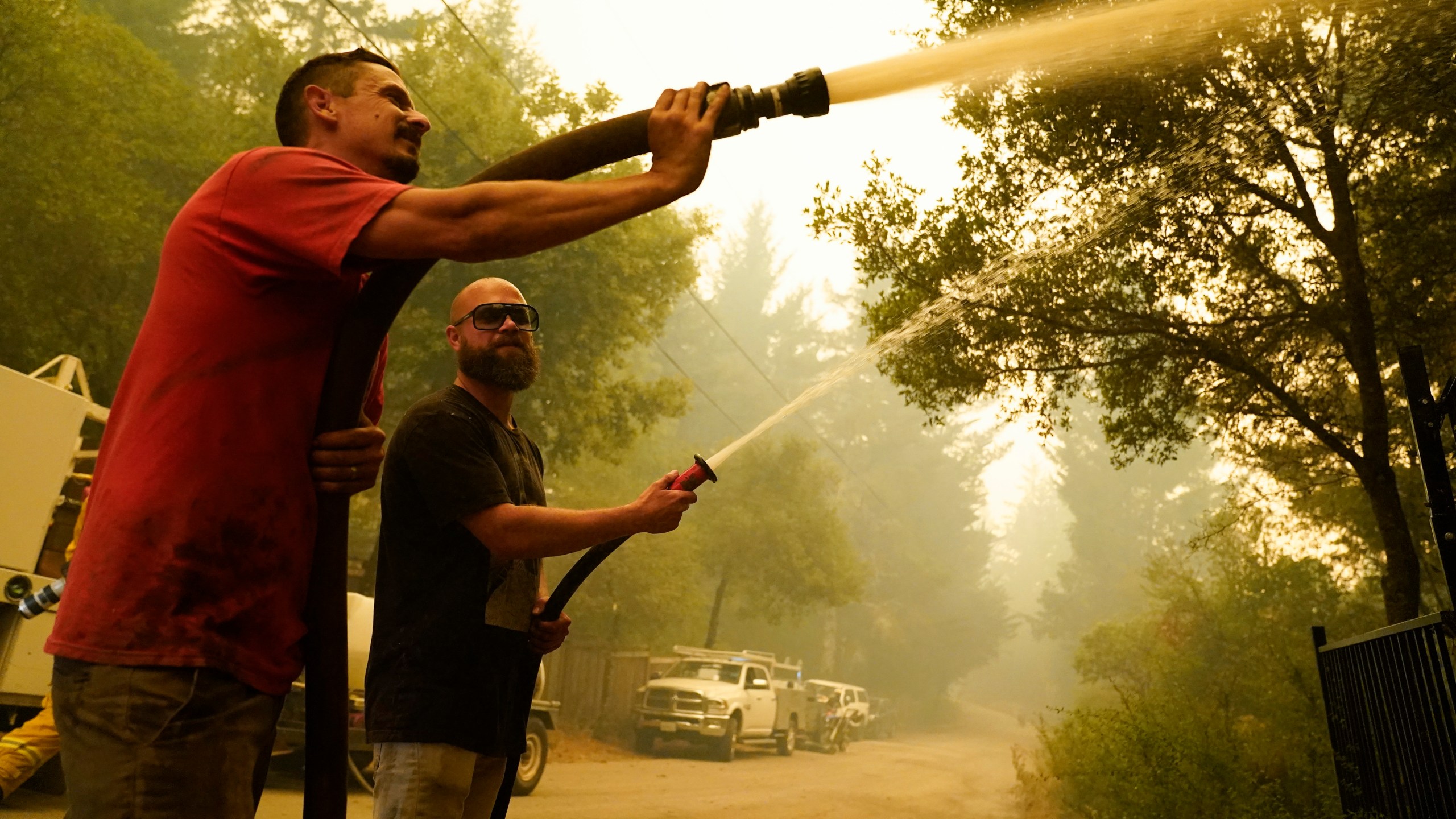 Civilian volunteers fight the CZU Lightning Complex Fire in Bonny Doon, California, on Aug. 20, 2020. (AP Photo/Marcio Jose Sanchez, File)