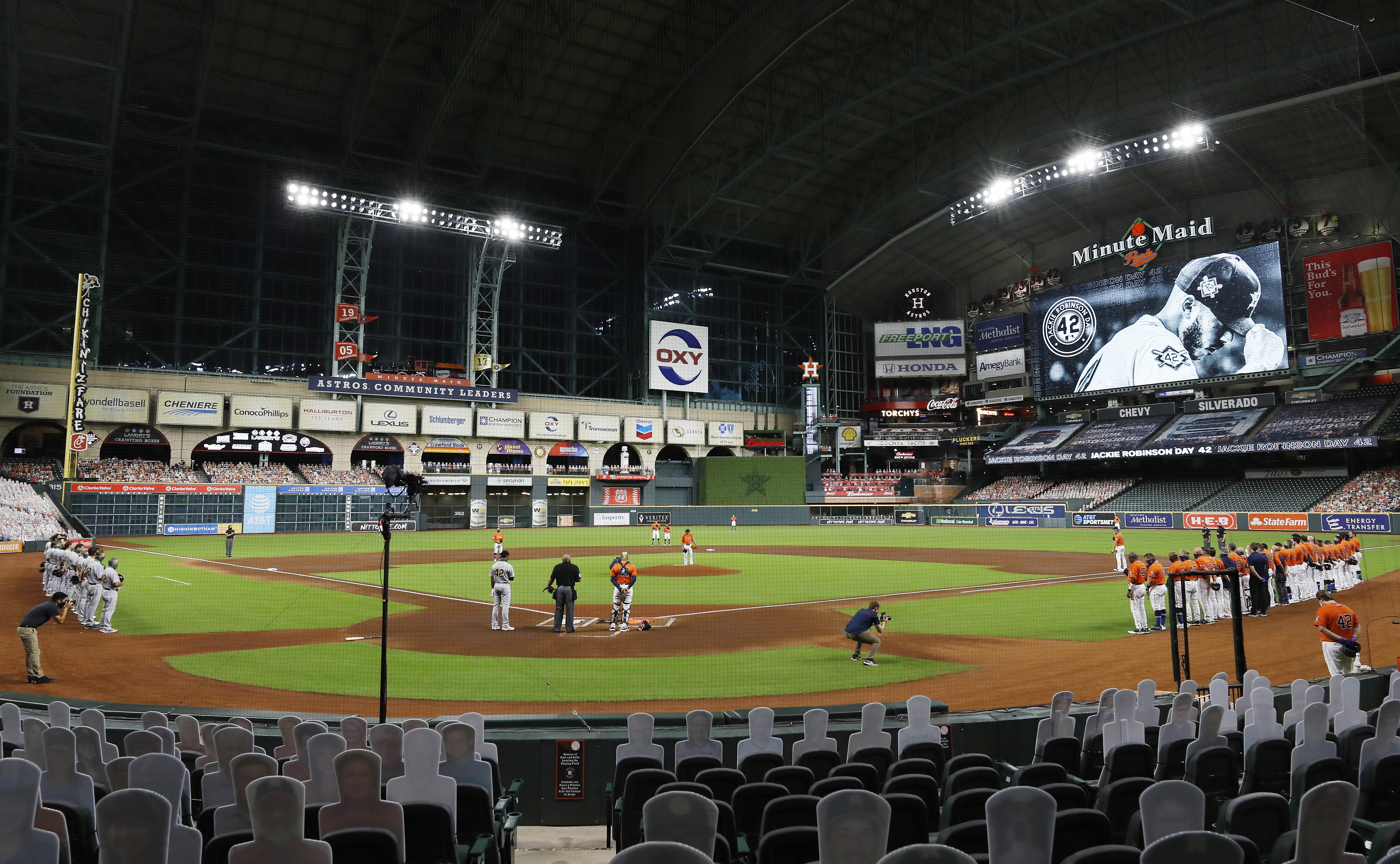 The Oakland Athletics and the Houston Astros stand together in a moment of silence before leaving the field without playing their scheduled baseball game in a protest of racial injustice on Aug. 28, 2020, in Houston. (Kevin M. Cox/The Galveston County Daily News via AP)