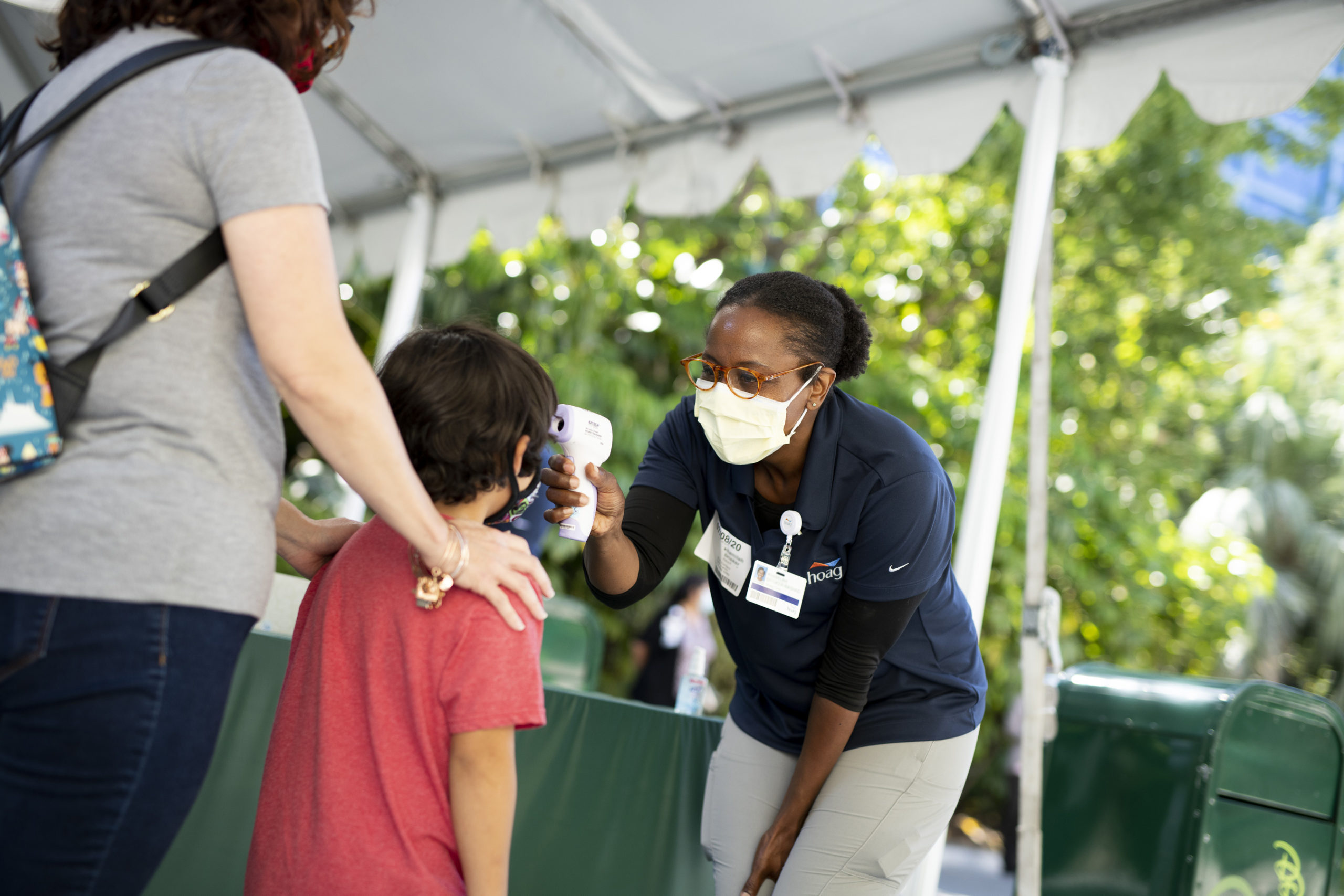 A child has his temperature taken in Downtown Disney on July 9, 2020, in Anaheim, Orange County. (Derek Lee/Disneyland Resort via Getty Images)