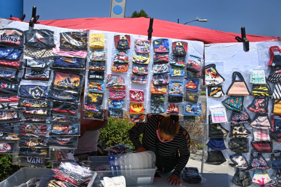 A vendor sells masks outside a Walmart store, July 22, 2020 in Burbank. (ROBYN BECK/AFP via Getty Images)