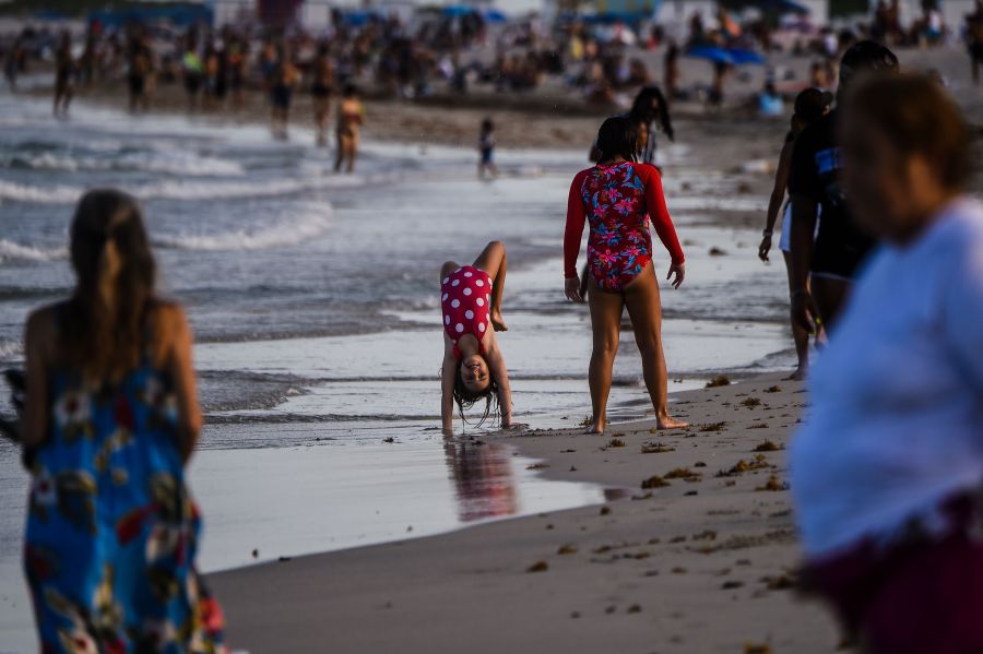 Children play on the beach in Miami Beach, Florida on July 28, 2020, amid the coronavirus pandemic. (CHANDAN KHANNA/AFP via Getty Images)