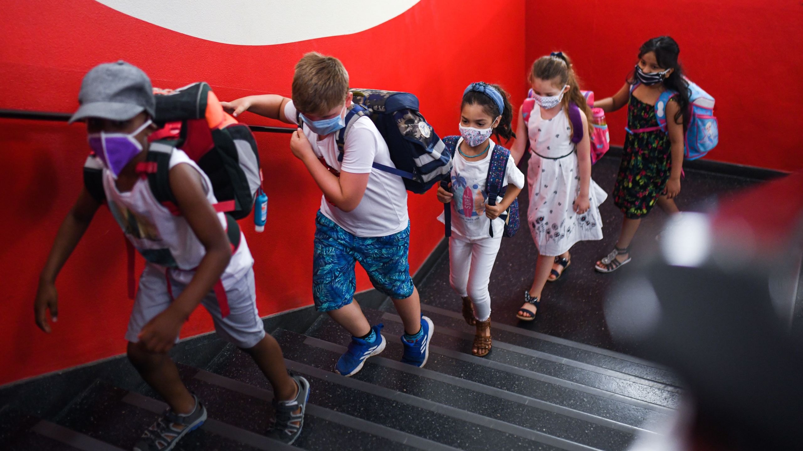 Students with face masks go upstairs to their classrooms at the Petri primary school in Dortmund, western Germany, on Aug. 12, 2020, amid the pandemic. (INA FASSBENDER/AFP via Getty Images)