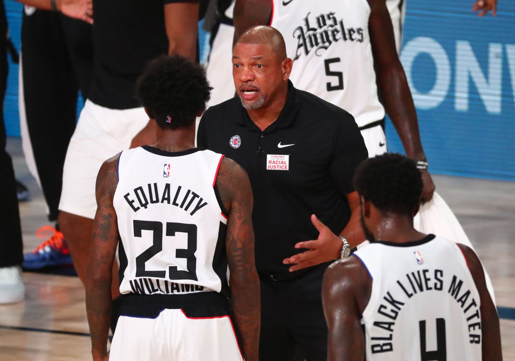 Head coach Doc Rivers of the L.A. Clippers talks with guard Lou Williams No. 23 in the first half against the Dallas Mavericks in game five of the first round of the 2020 NBA Playoffs at ESPN Wide World Of Sports Complex on Aug. 25, 2020 in Lake Buena Vista, Florida. (Klement-Pool/Getty Images)