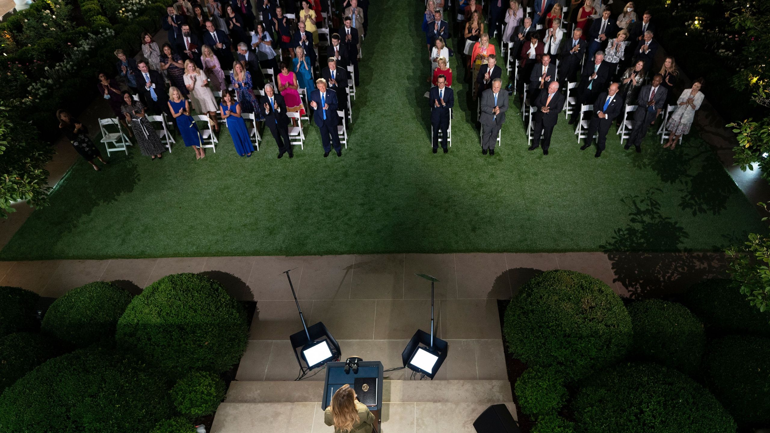 President Donald Trump along with Vice President Mike Pence and Second Lady Karen Pence applaud first lady Melania Trump as she arrives to address the Republican Convention during its second day from the Rose Garden of the White House on Aug. 25, 2020. (BRENDAN SMIALOWSKI/AFP via Getty Images)