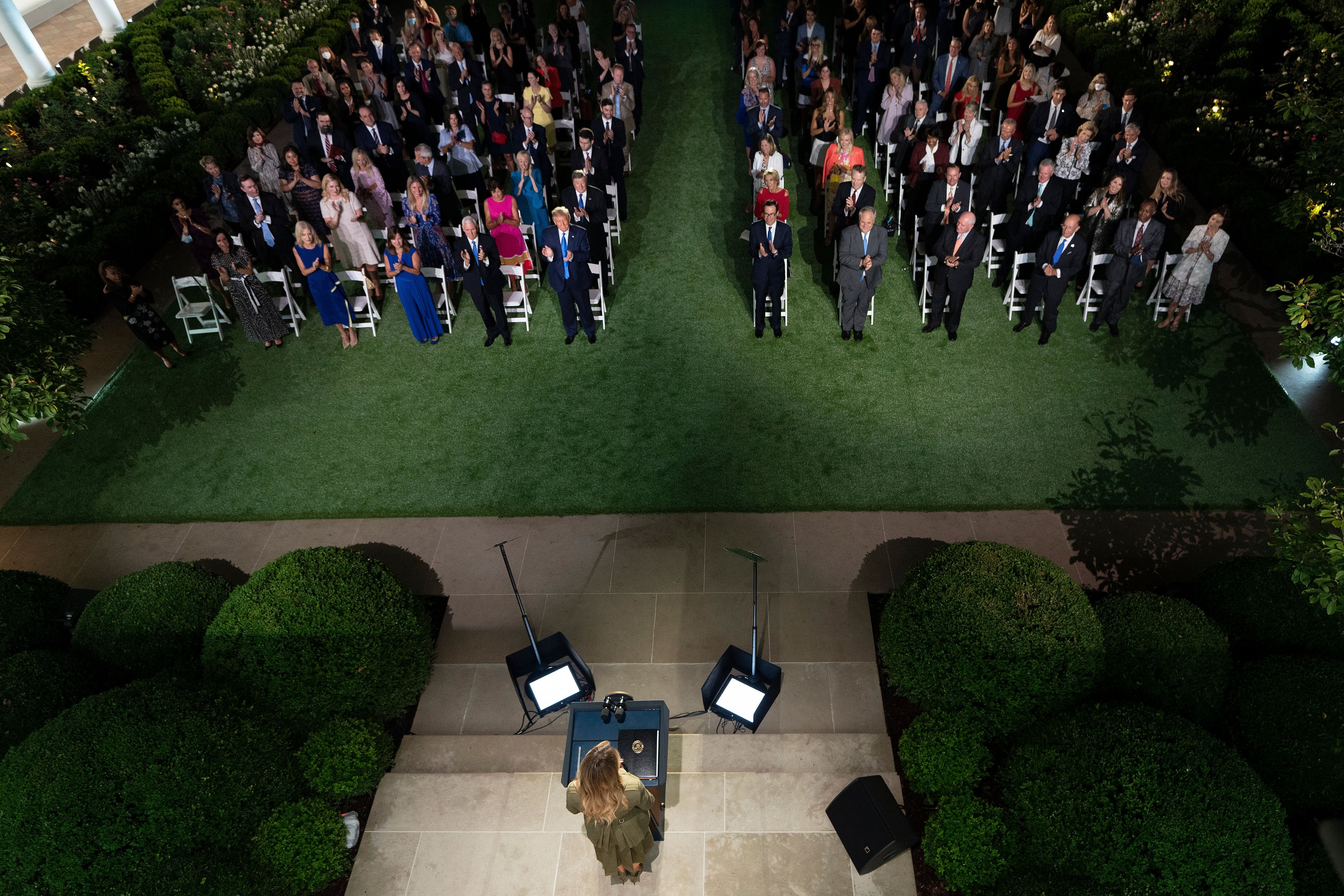 President Donald Trump along with Vice President Mike Pence and Second Lady Karen Pence applaud first lady Melania Trump as she arrives to address the Republican Convention during its second day from the Rose Garden of the White House on Aug. 25, 2020. (BRENDAN SMIALOWSKI/AFP via Getty Images)