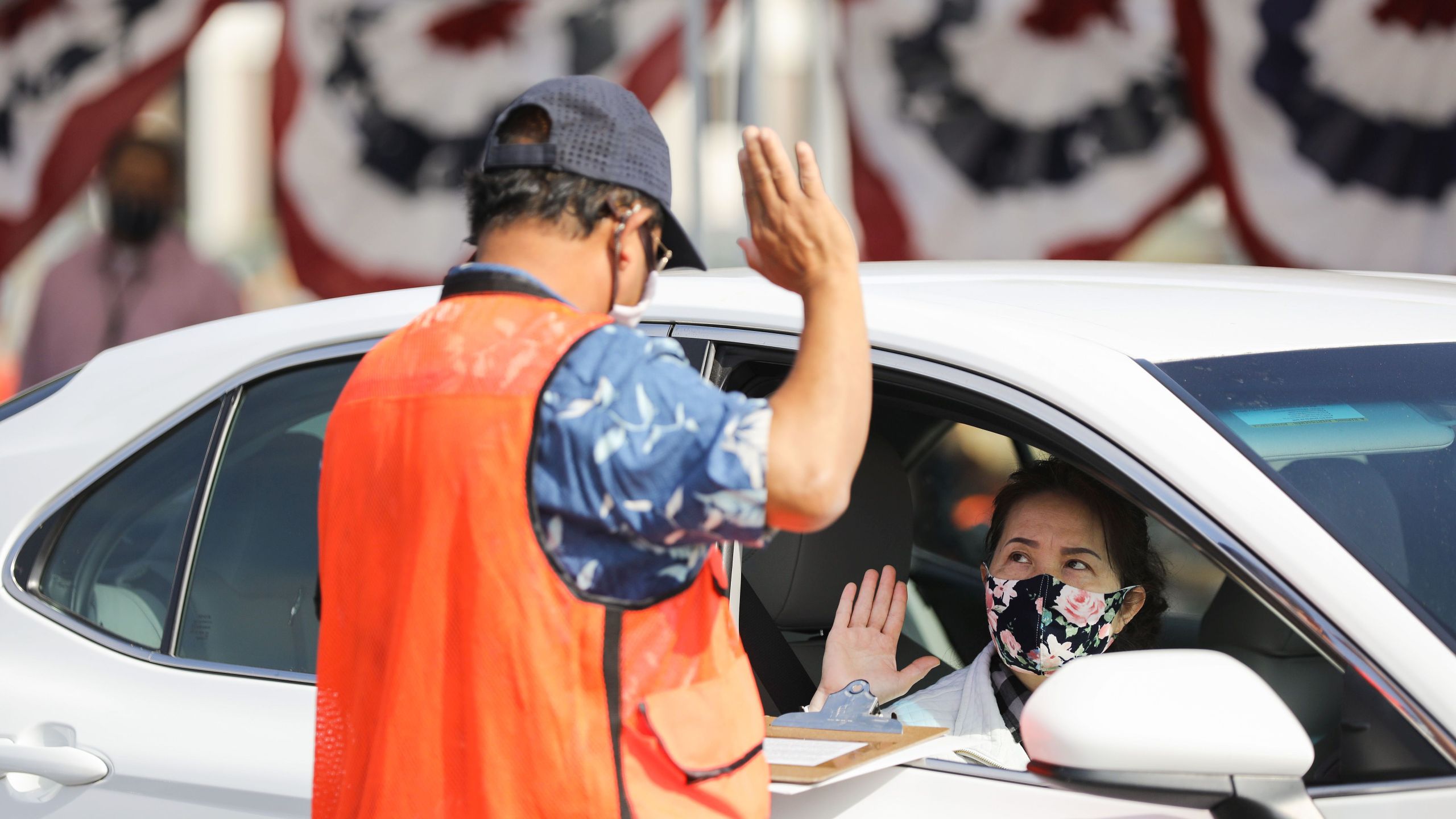 A woman is sworn in as a new U.S. citizen from inside a vehicle at a drive-in naturalization ceremony conducted amid the COVID-19 pandemic on July 29, 2020 in Santa Ana. (Mario Tama/Getty Images)