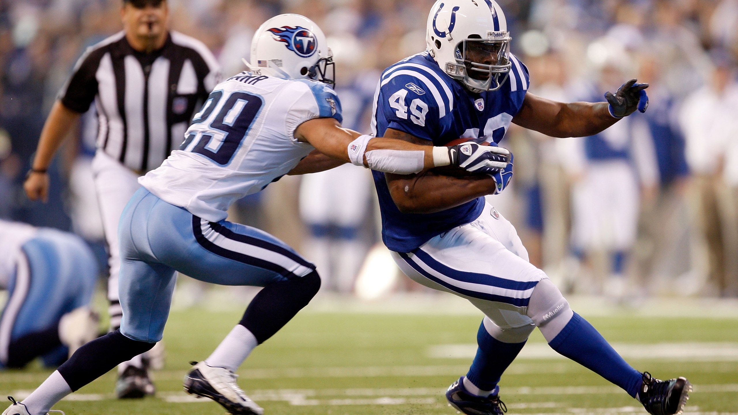 Najeh Davenport, No. 49, of the Indianapolis Colts carries the ball as Chris Carr, No. 29, of the Tennessee Titans defends during the game at Lucas Oil Stadium Dec. 28, 2008 in Indianapolis, Indiana. (Jamie Squire/Getty Images)