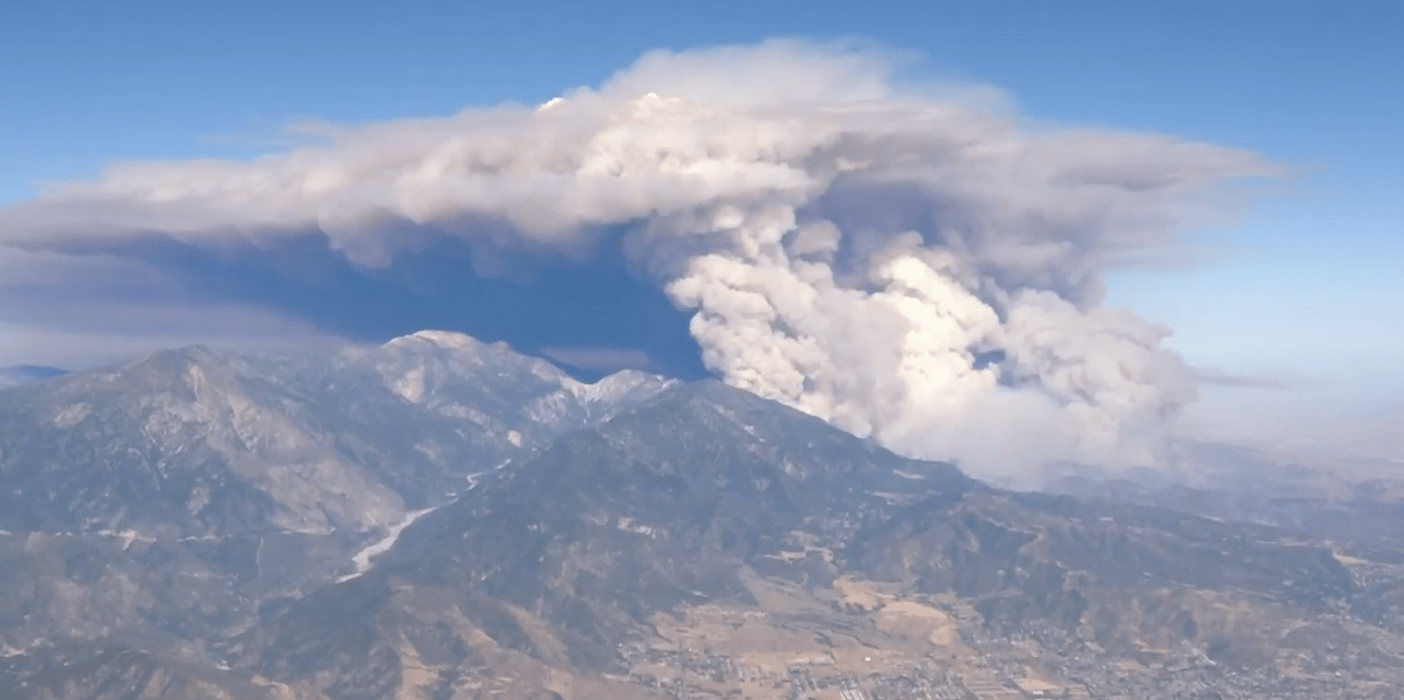 The Apple Fire burns through Cherry Valley on the afternoon of Aug. 1, 2020, after scorching more than 6 square miles. It erupted in the Riverside County community the night before. (KTLA)