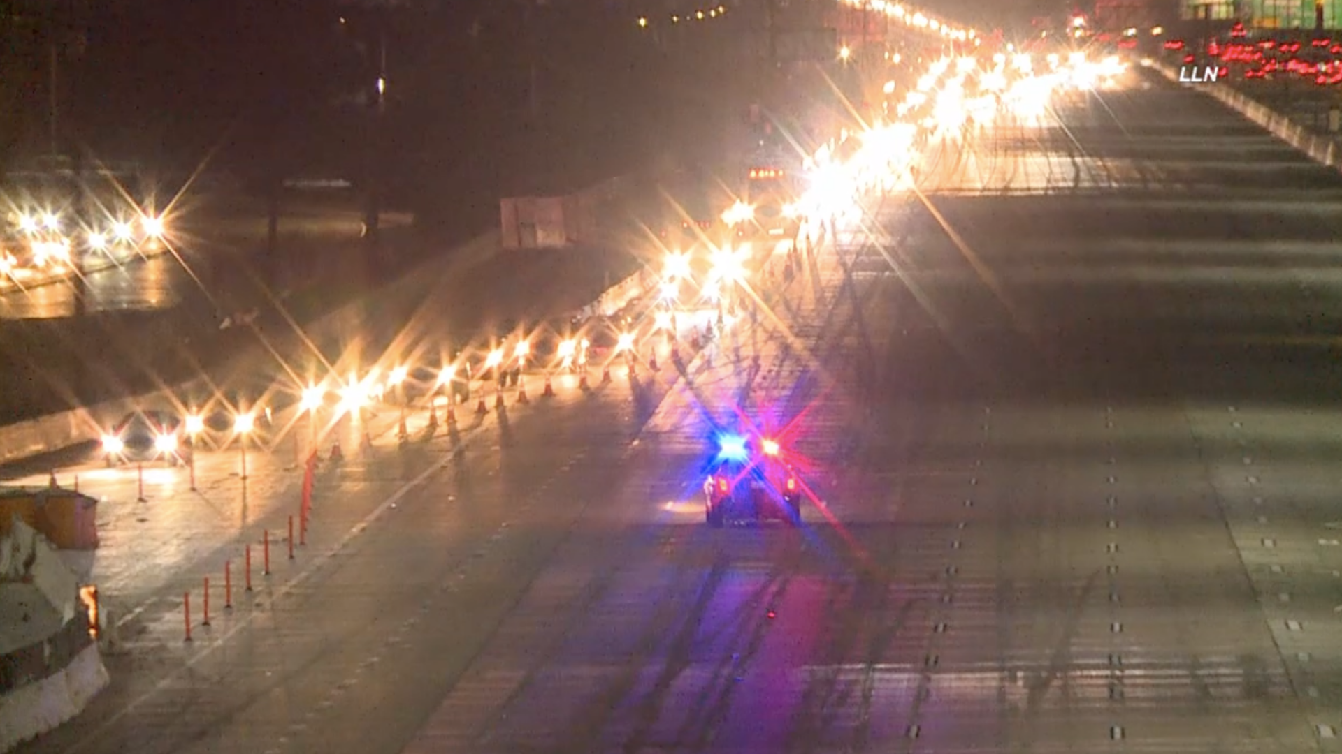 A police vehicle is seen on the 405 Freeway in the Seal Beach area as a long line of vehicles exit the freeway during a deadly shooting investigation on Aug. 29, 2020. (Loudlabs)