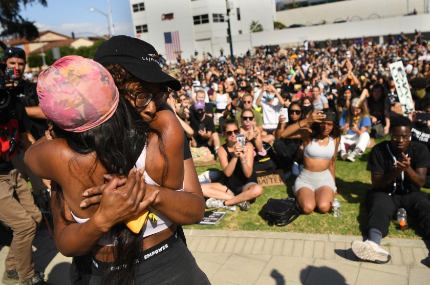 A family member of Breonna Taylor is hugged by another woman after speaking to protesters in Beverly Hills on June 6, 2020. (Wally Skalij / Los Angeles Times)