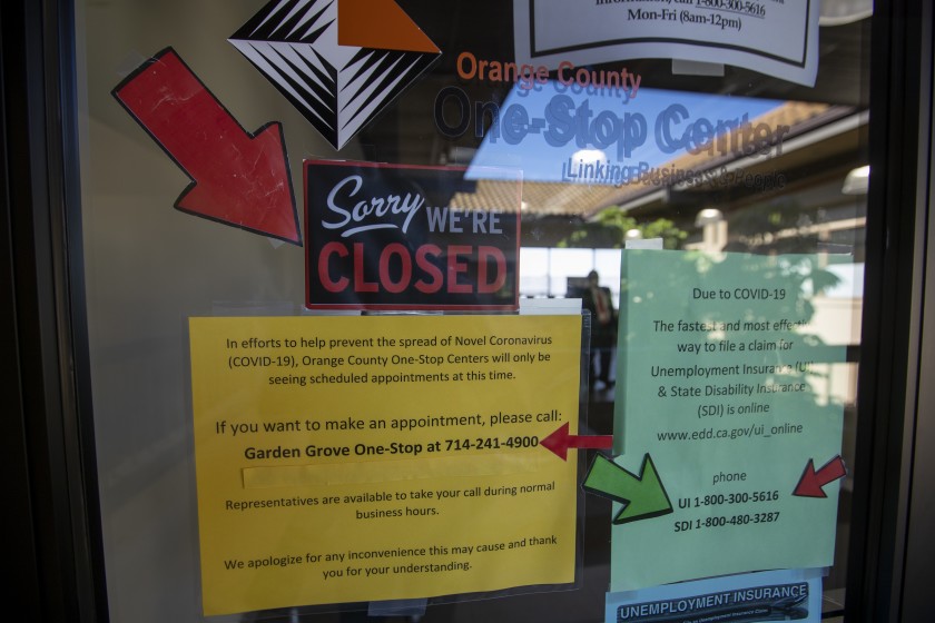 Signs are posted in May on the doors of the Orange County One-Stop Center in Garden Grove, which provides employment and training services.(Allen J. Schaben / Los Angeles Times)