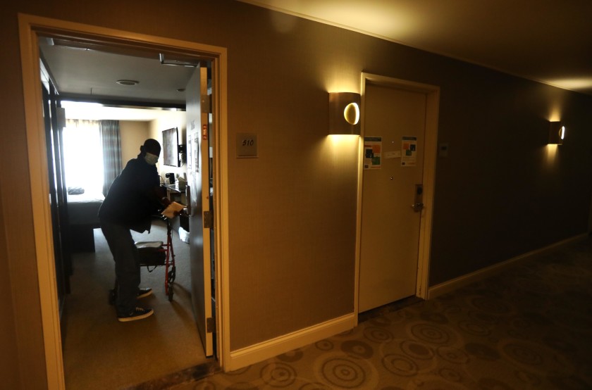 David William, 63, returns to his room at a Project Roomkey hotel in Los Angeles. (Genaro Molina / Los Angeles Times)