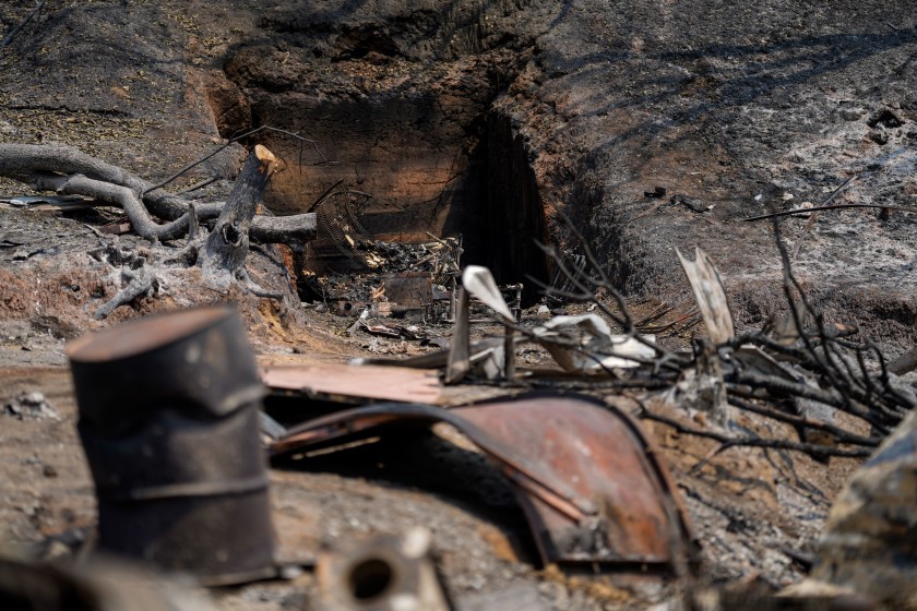 Burned-out wreckage lies at a property along California 128 where the LNU Lightning Complex fire tore through last week.(Kent Nishimura / Los Angeles Times)