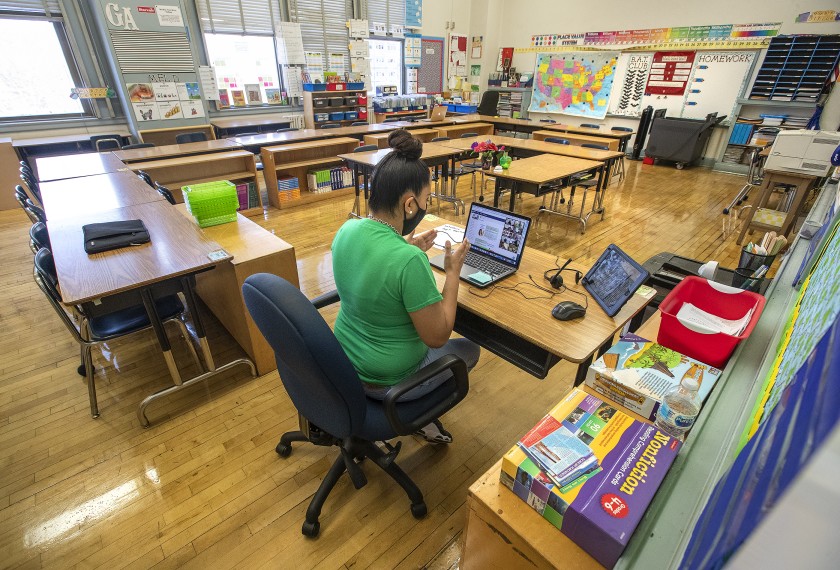 Manchester Ave. Elementary School 5th grade teacher Gladys Alvarez talks to her students during a virtual zoom class inside her empty classroom.(Mel Melcon / Los Angeles Times)