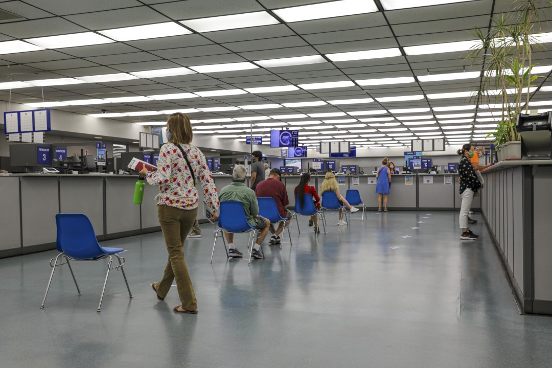 Clients stay 6 feet apart while waiting for their turn at a DMV office in Westminster in August 2020. (Irfan Khan / Los Angeles Times)