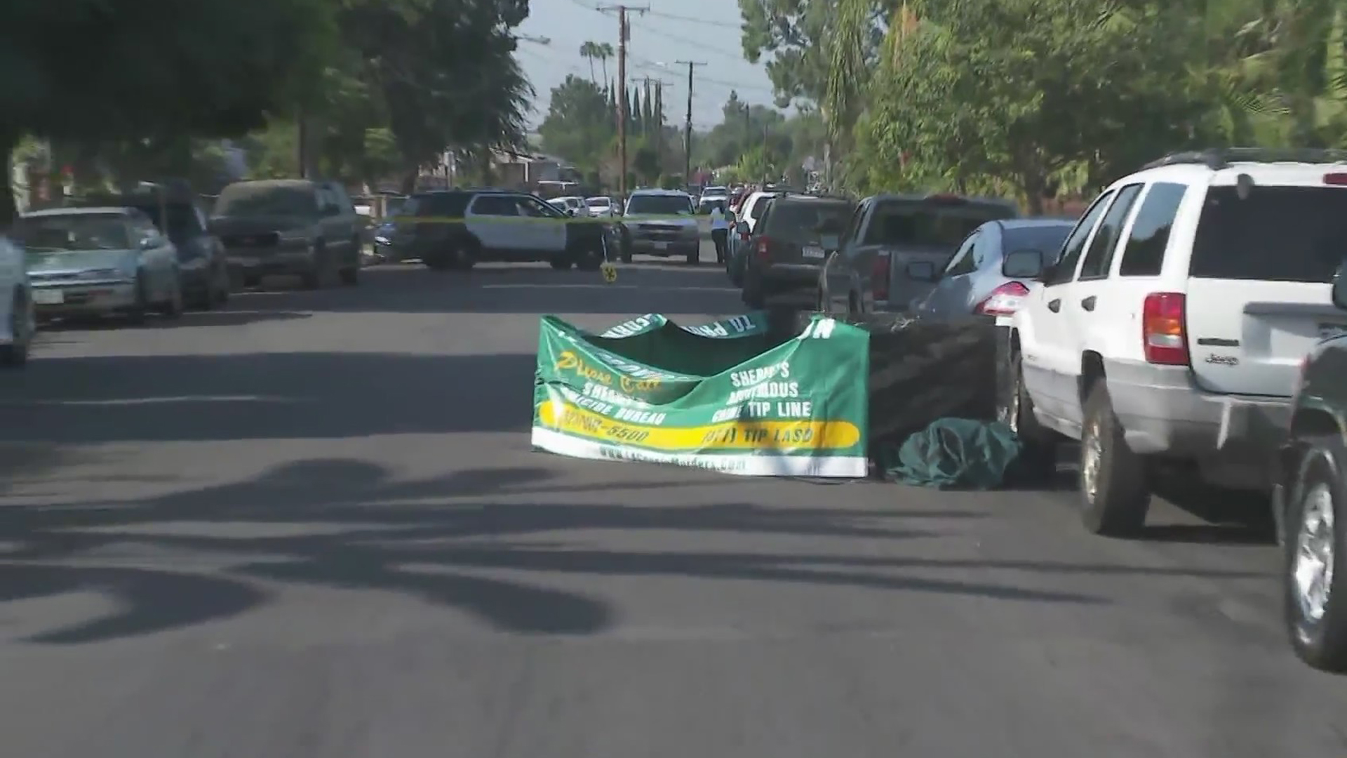 A tarp surrounds the area of a death investigation in Duarte on Aug. 25, 2020. (KTLA)