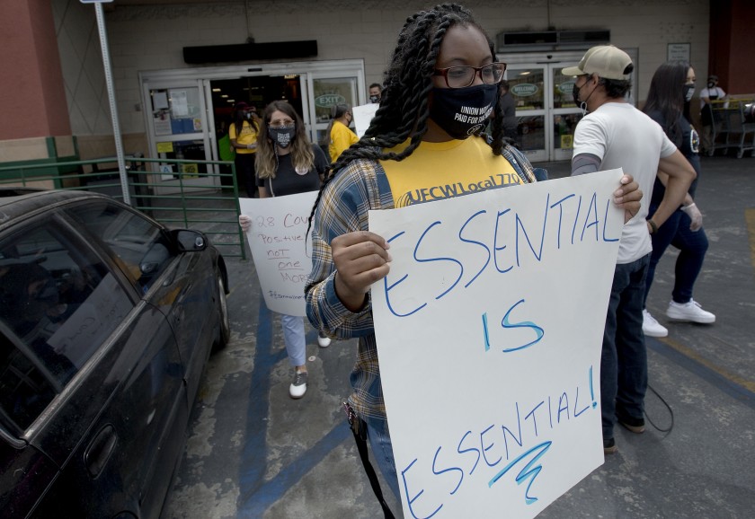 Grocery workers demonstrate outside a Food 4 Less store in Los Angeles where multiple COVID-19 cases have been reported in July 2020. (Luis Sinco / Los Angeles Times)