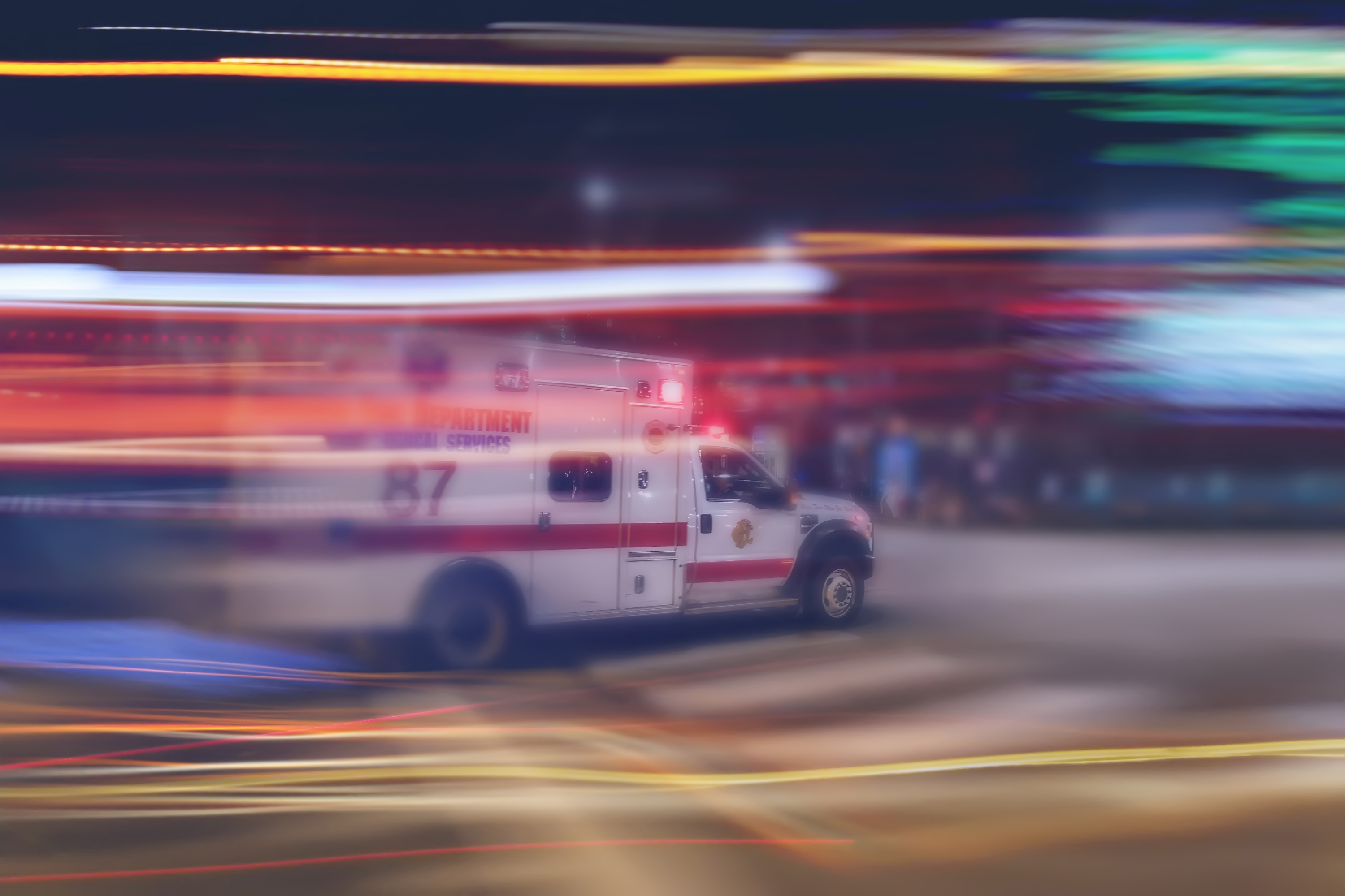 An ambulance speeds through traffic in a file image. (Credit: iStock / Getty Images Plus)