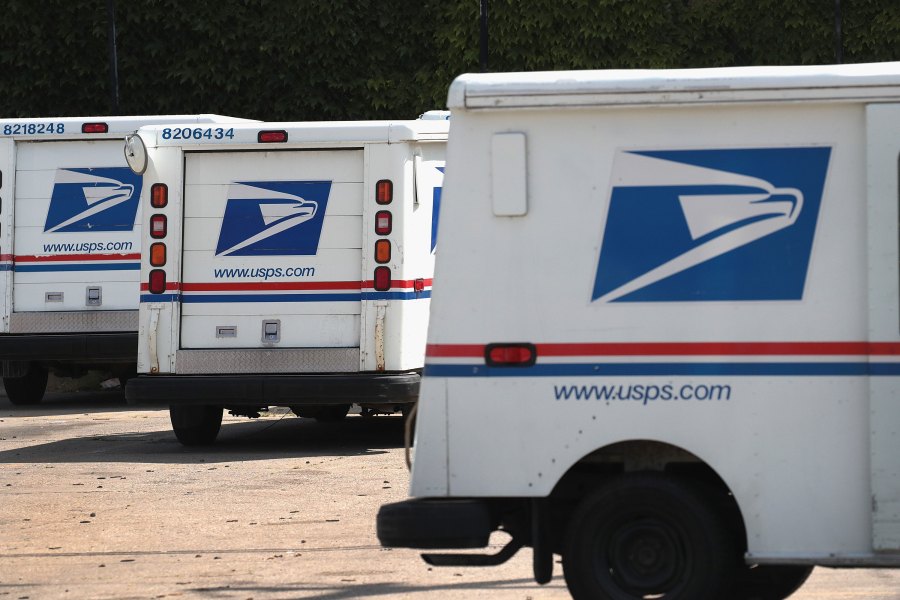 United States Postal Service (USPS) trucks are parked at a postal facility on August 15, 2019. In its recent quarterly statement the USPS reported a loss of nearly $2.3 billion and a 3.2 percent decline in package deliveries, the first decline in nearly a decade. (Scott Olson/Getty Images)