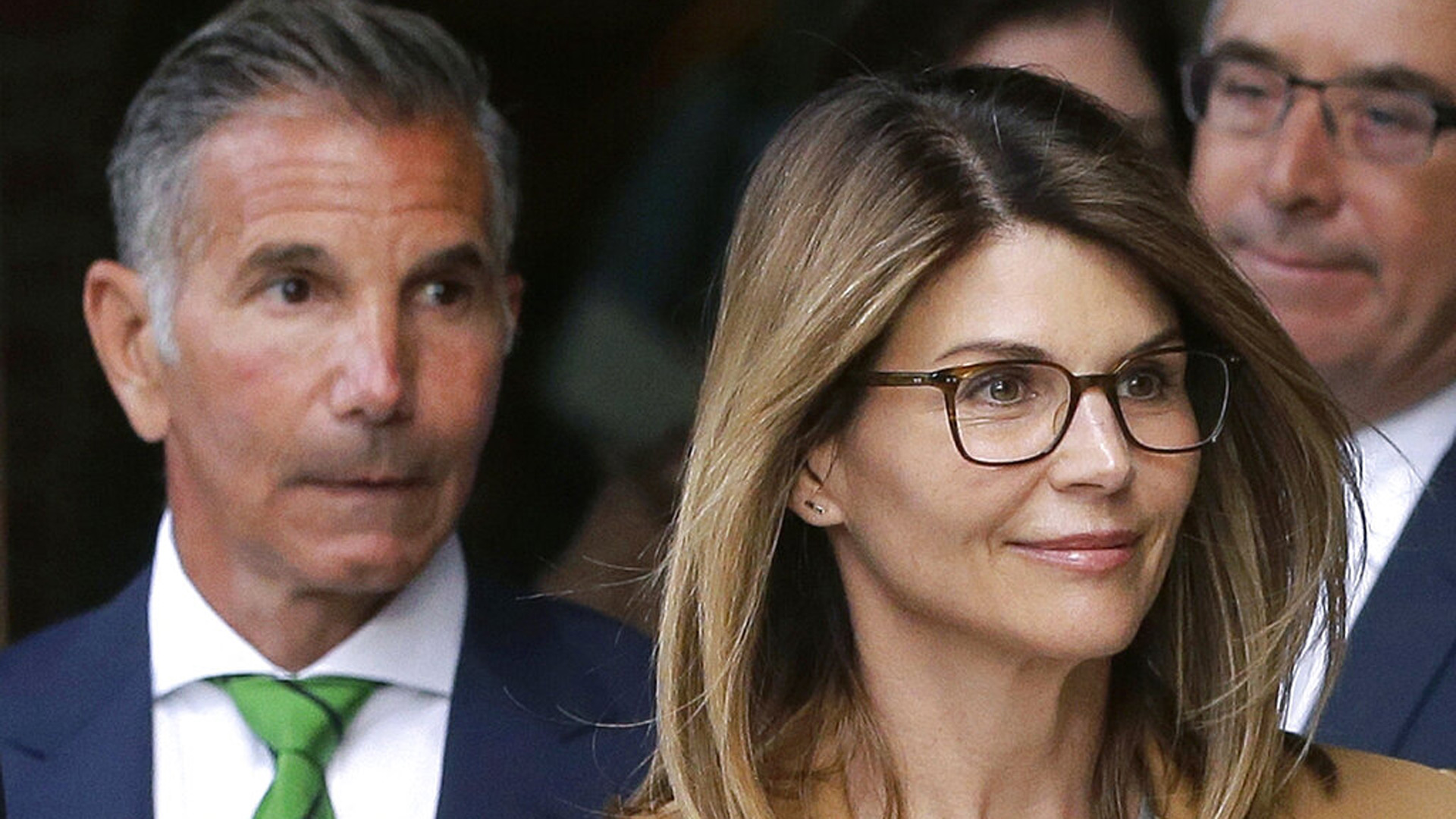 In this April 3, 2019 file photo, actress Lori Loughlin, front, and husband, clothing designer Mossimo Giannulli, left, depart federal court in Boston. (AP Photo/Steven Senne, File)