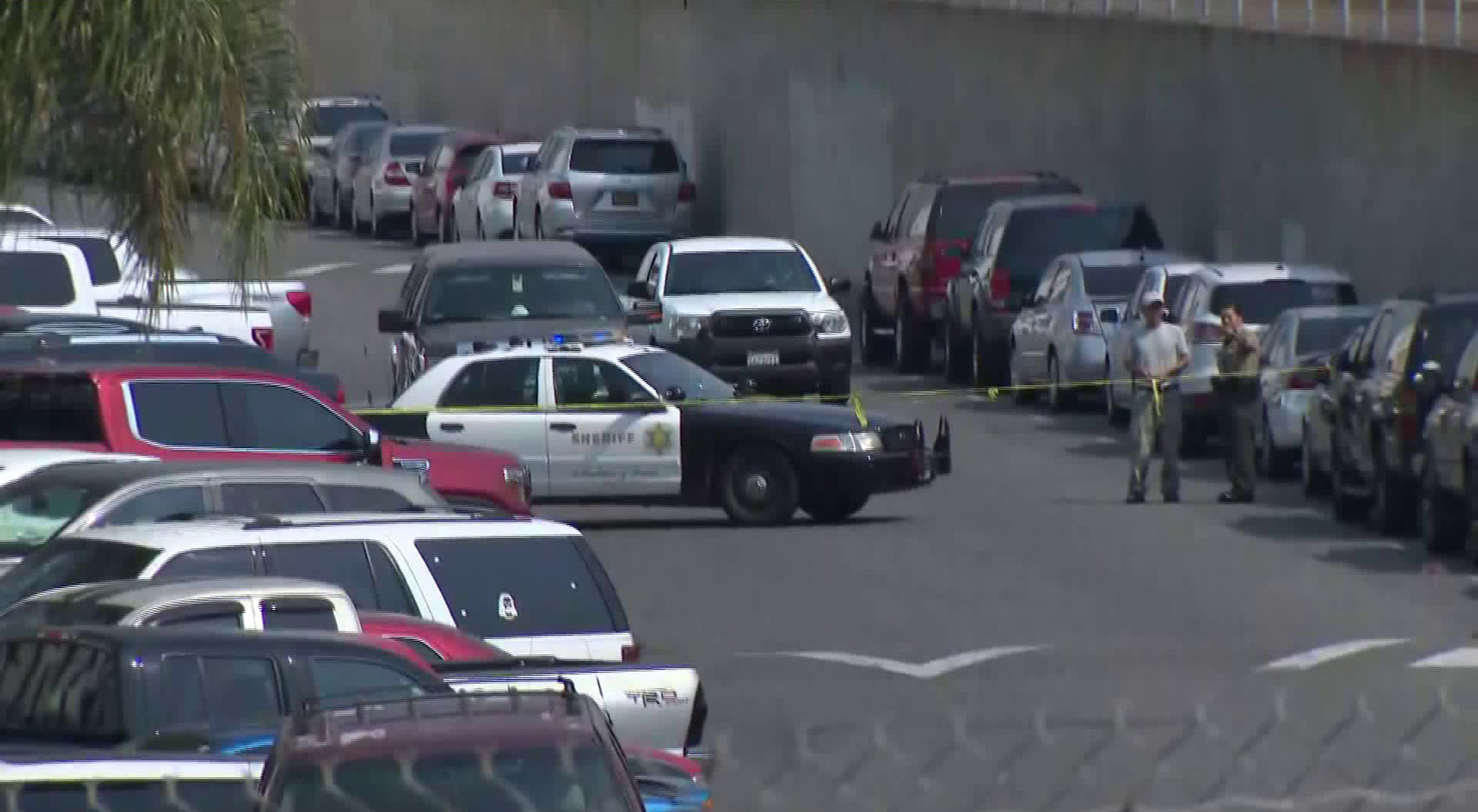 A Los Angeles County Sheriff's Department official speaks to someone near the scene of a fatal shooting in Maywood on Aug. 20, 2020. (KTLA)