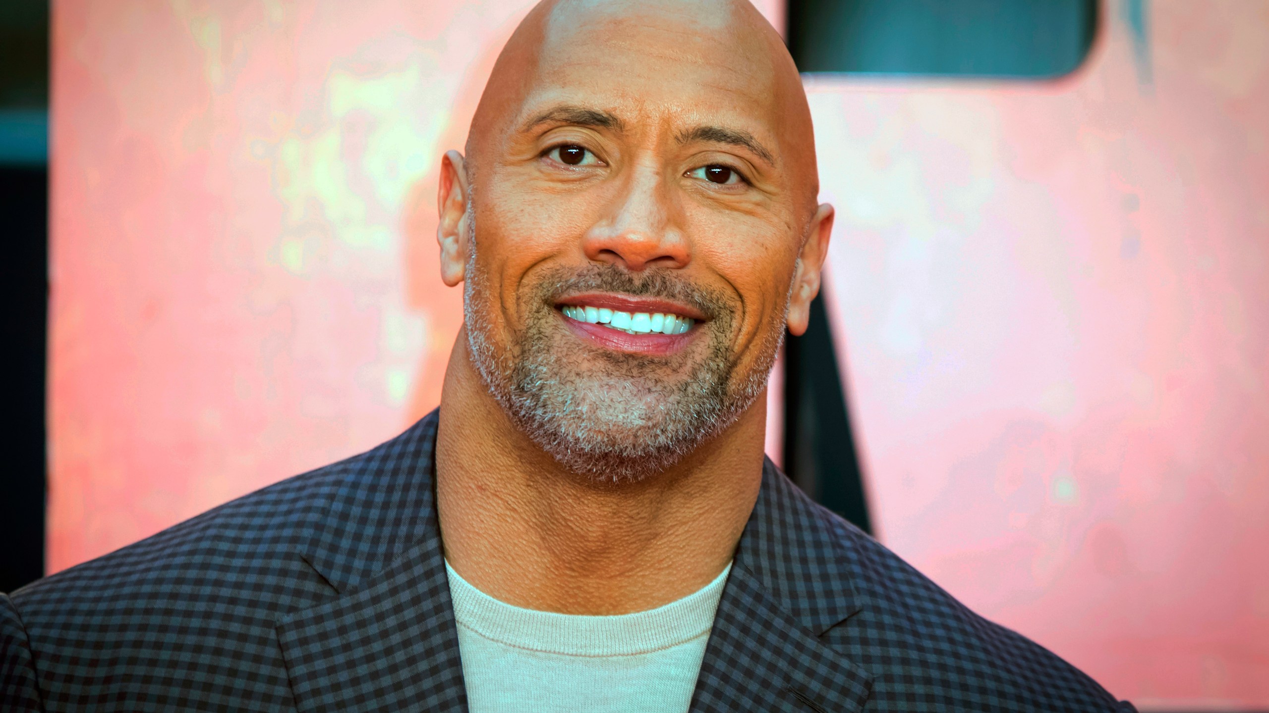 FILE - In this April 11, 2018, file photo, actor Dwayne Johnson poses for photographers at the premiere of the "Rampage," in London. (Vianney Le Caer / Invision / Associated Press)