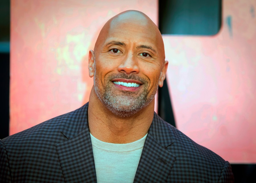 FILE - In this April 11, 2018, file photo, actor Dwayne Johnson poses for photographers at the premiere of the "Rampage," in London. (Vianney Le Caer / Invision / Associated Press)