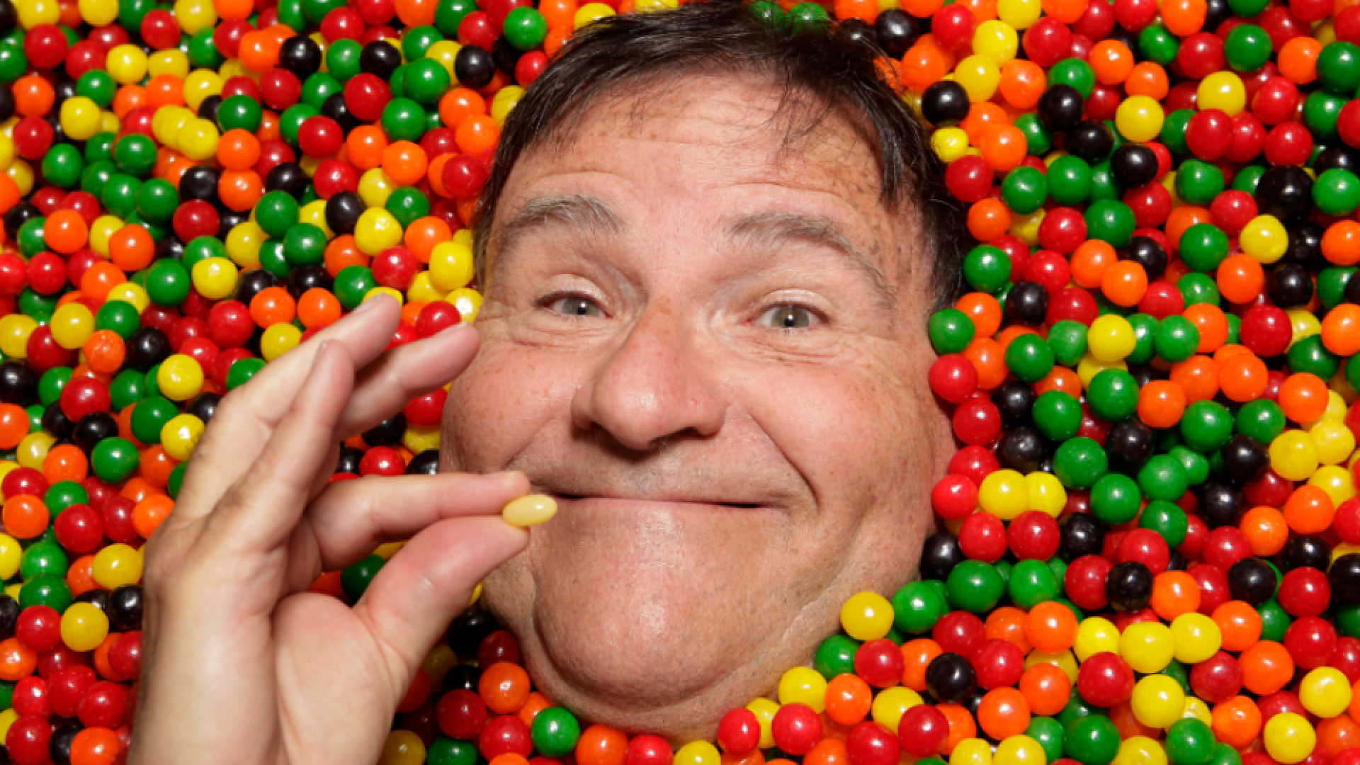 In this Oct. 12, 2011 photo, David Klein, a man who invented the Jelly Belly, poses for photos in Covina. Klein is the Willie Wonka of this small Los Angeles suburb, joyfully leading children and their parents past mounds of chewy, crunchy, sugary confections with names like Sandy Candy, Zombie Heart and Gummy Bacon. (AP Photo/Jae C. Hong)