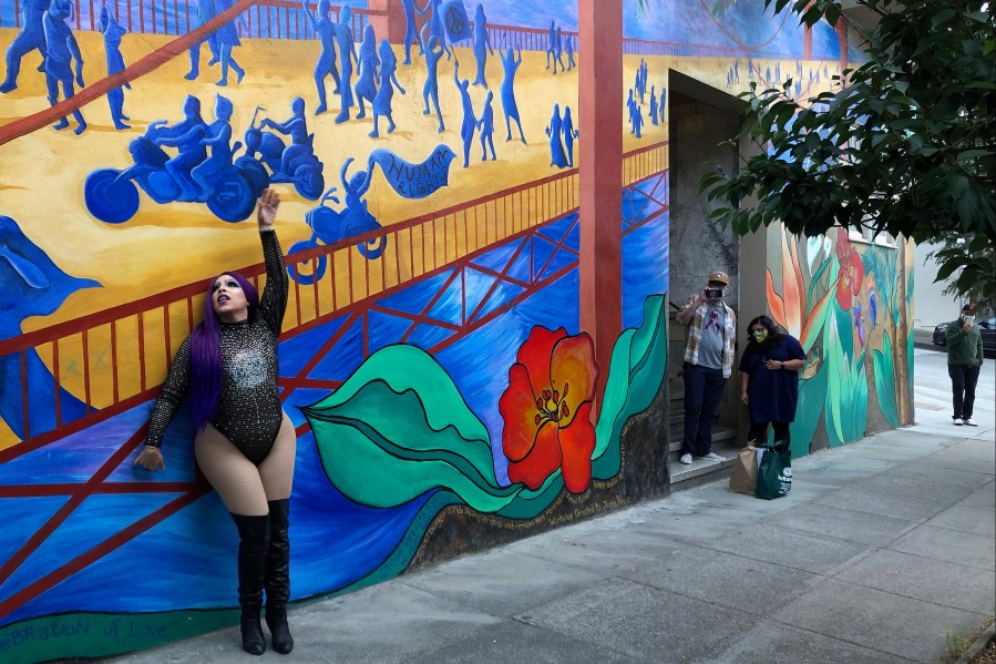 This Aug. 28, 2020 photo shows Amoura Teese performing on a sidewalk for customers in San Francisco. (AP Photo/Haven Daley)