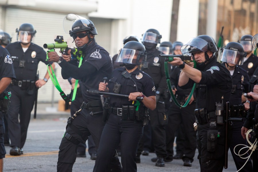 Police aim weapons on demonstrators protesting the death of George Floyd in Los Angeles, Saturday, May 30, 2020. (AP Photo/Ringo H.W. Chiu, File)