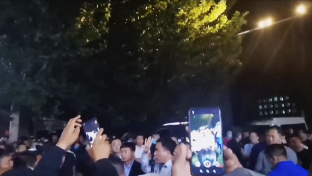 In this image from video taken in August 2020, parents confront authorities outside a school in Tongliao in Northwestern China's Inner Mongolia region. Ethnic Mongolians, including students and parents, in China’s Inner Mongolia region are demonstrating their anger in rare public protests against a new bilingual education policy that they say is endangering the Mongolian language. (AP Photo)