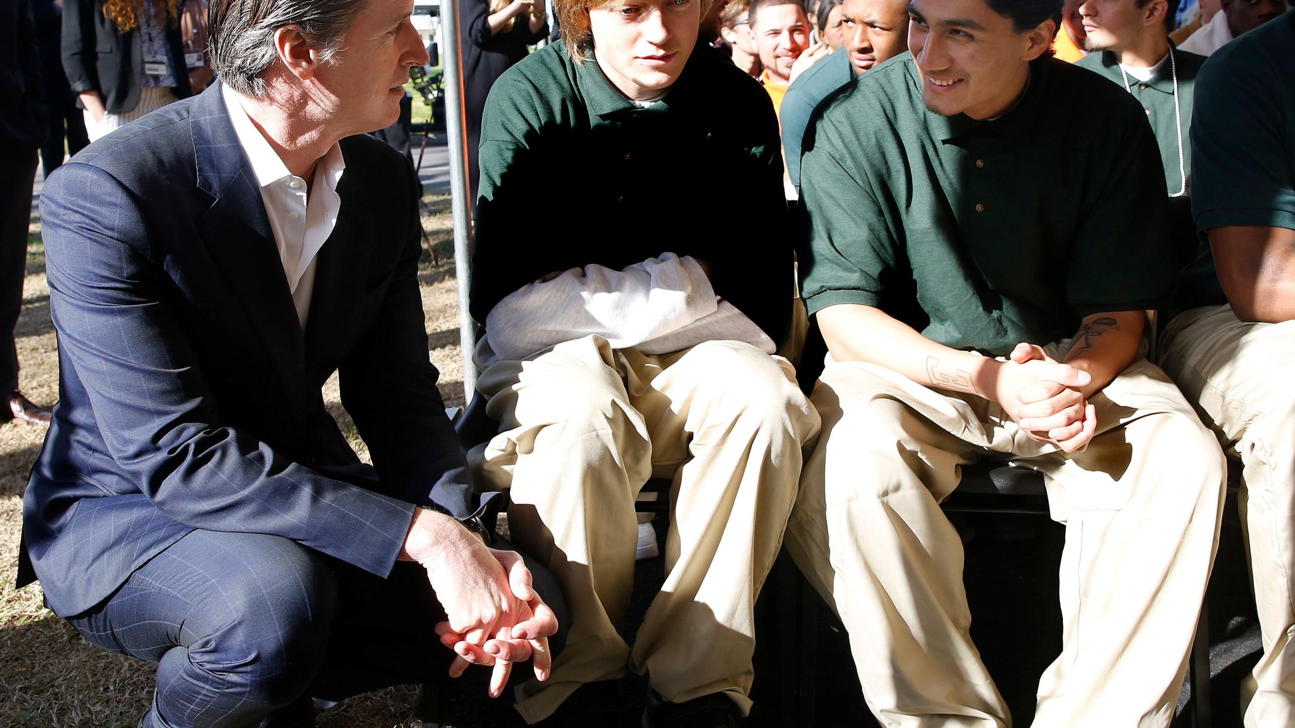 In this Jan. 22, 2019, file photo Gov. Gavin Newsom talks with Juan Cruz Lopez Jr. right, a youthful offender at the O.H. Close Youth Correctional Facility, in Stockton. (AP Photo/Rich Pedroncelli,File)