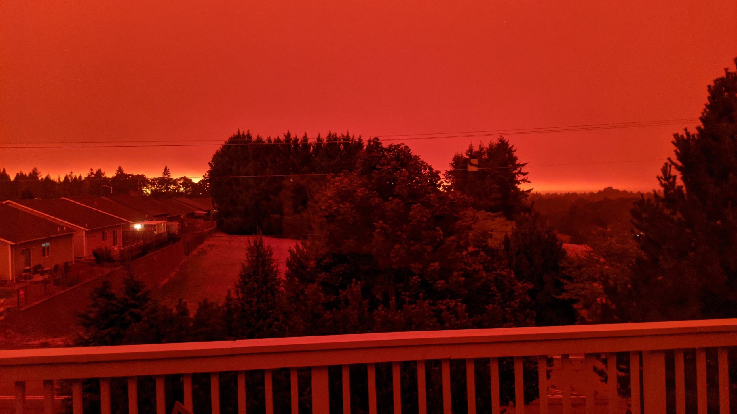 This photo taken from the home of Russ Casler in Salem, Ore., shows the smoke-darkened sky well before sunset at around 5 p.m., Tuesday, Sept. 8, 2020. Strong winds and high temperatures continued to fuel catastrophic fires in many parts of Oregon on Wednesday, forcing thousands of people to flee from their homes and making for poor air quality throughout the West. Huge wildfires also continued to grow in neighboring Washington state. (Russ Casler via AP)