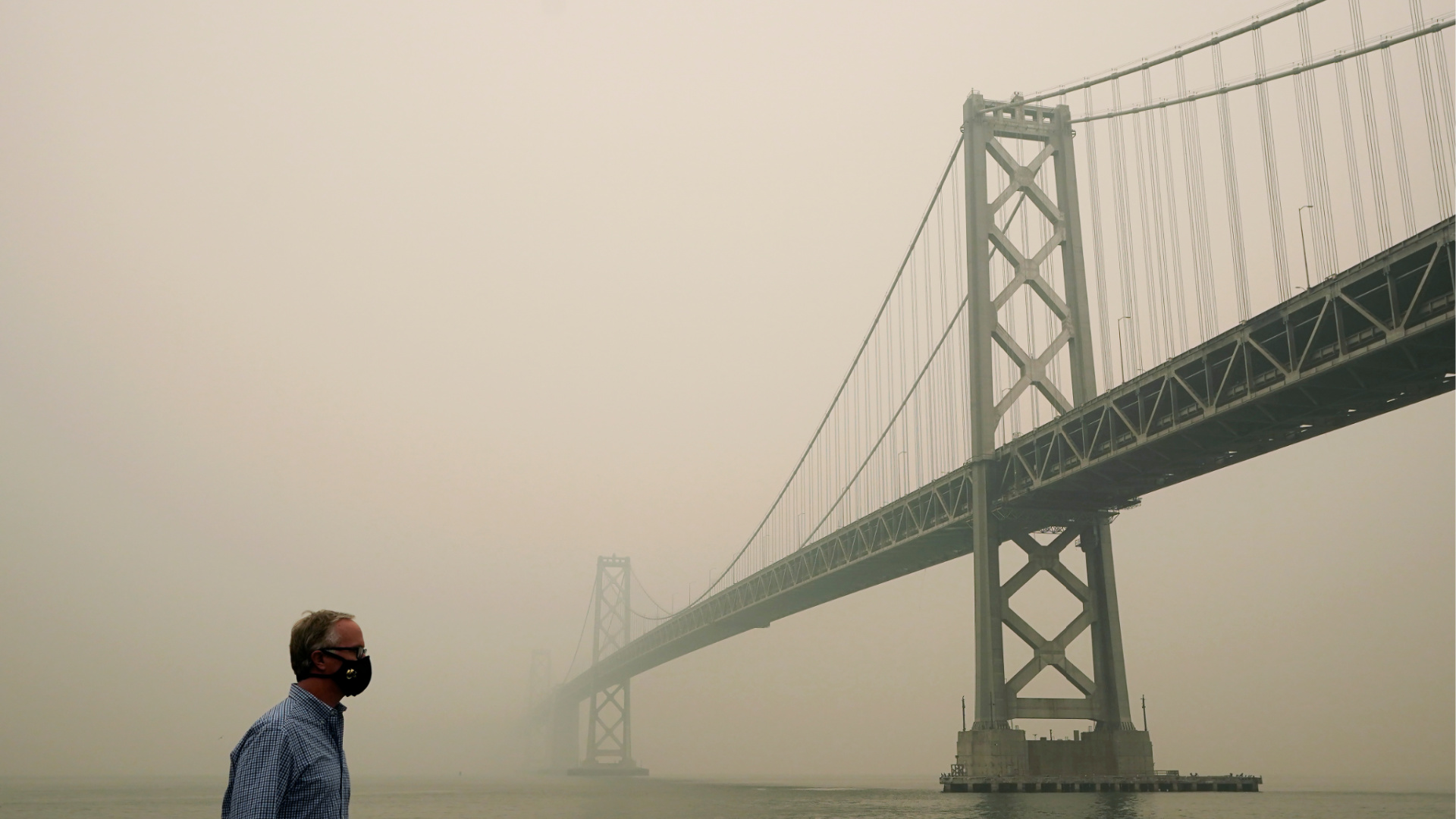 Smoke and haze from wildfires partially obscures the view of the San Francisco-Oakland Bay Bridge along the Embarcadero in San Francisco on Sept. 10, 2020. (AP Photo/Jeff Chiu)