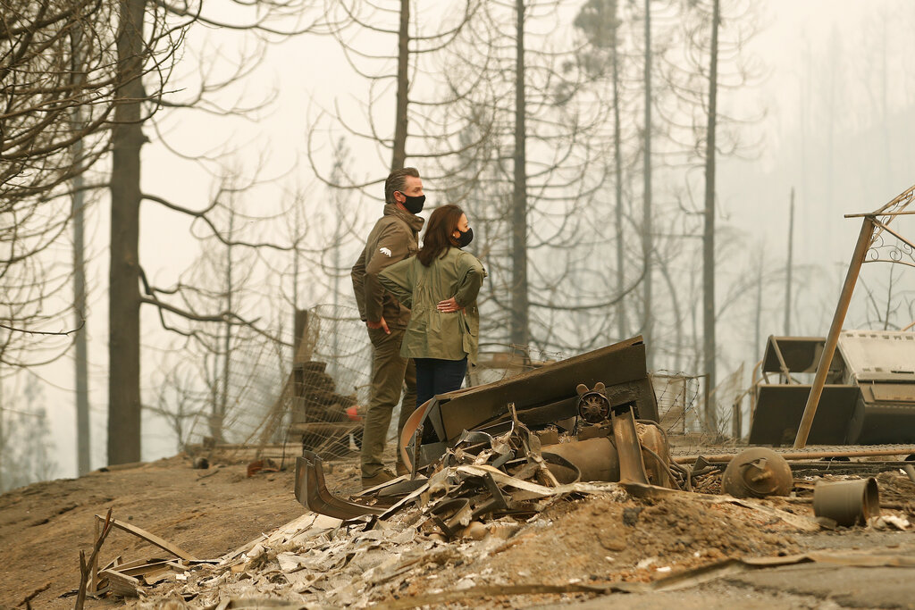 California Gov. Gavin Newsom and Democratic vice presidential candidate Sen. Kamala Harris, D-Calif., talk as they asses the damage during the Creek Fire at Pine Ridge Elementary, Tuesday, Sept. 15, 2020, in Auberry, Calif. (AP Photo/Gary Kazanjian)