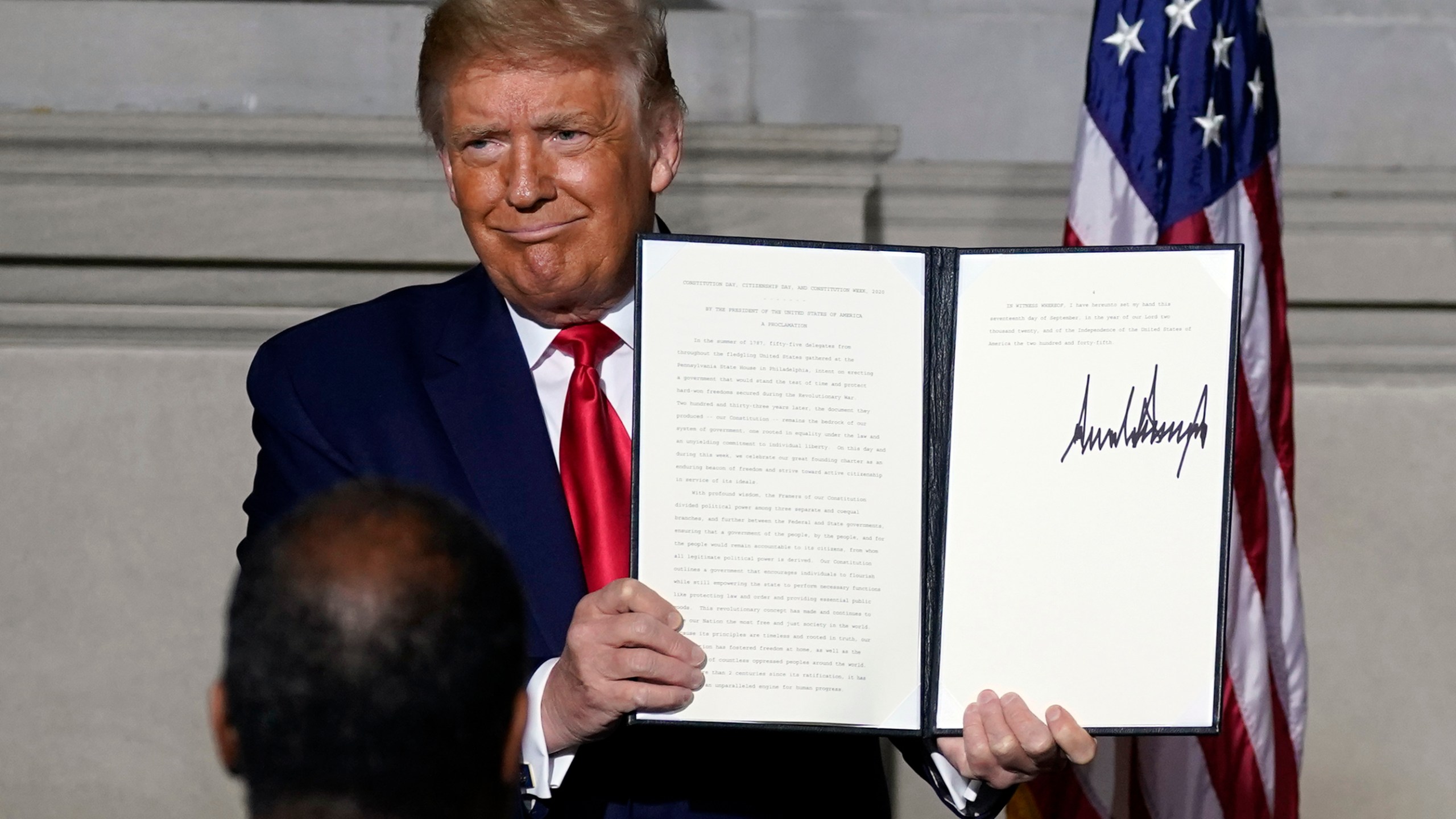 President Donald Trump holds a signed Constitution Day proclamation after he spoke to the White House conference on American History at the National Archives museum, Thursday, Sept. 17, 2020, in Washington. (AP Photo/Alex Brandon)