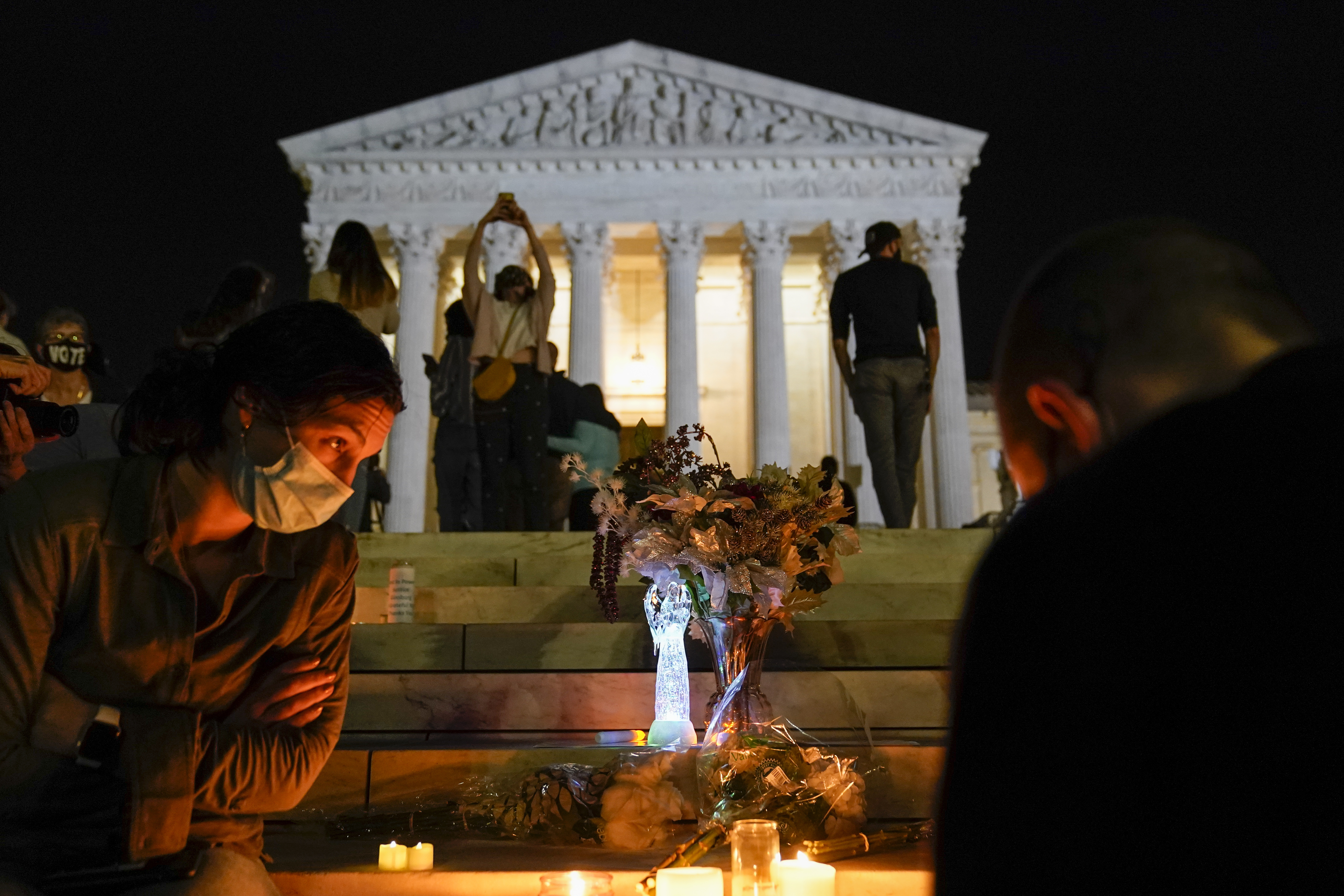 People gather at the Supreme Court on Sept. 18, 2020, after the court announced that Justice Ruth Bader Ginsburg died of metastatic pancreatic cancer at age 87. (Alex Brandon / Associated Press)