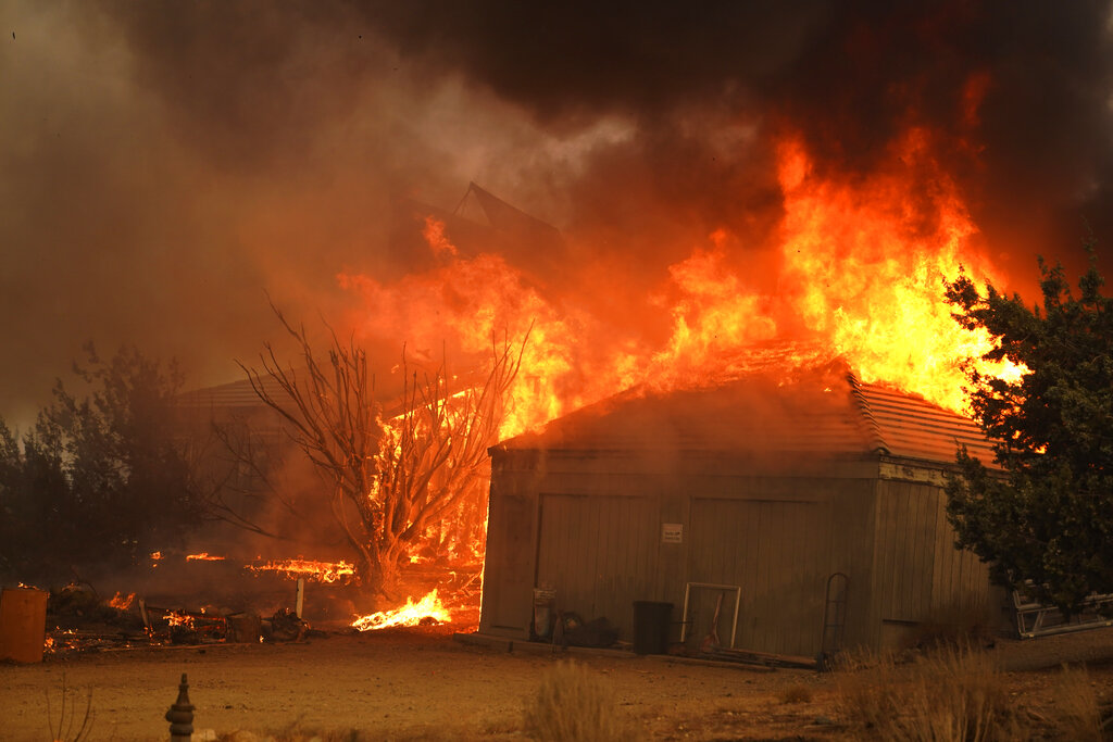 A home burns along Cima Mesa Rd. as the Bobcat Fire advances on Sept. 18, 2020, in Juniper Hills, Calif. (AP Photo/Marcio Jose Sanchez)