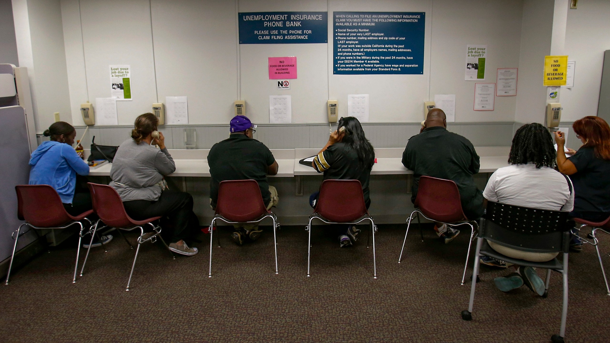 In this Sept. 20, 2013, file photo, visitors use the unemployment insurance phone bank at the California Employment Development Department office in Sacramento. (Rich Pedroncelli / Associated Press)