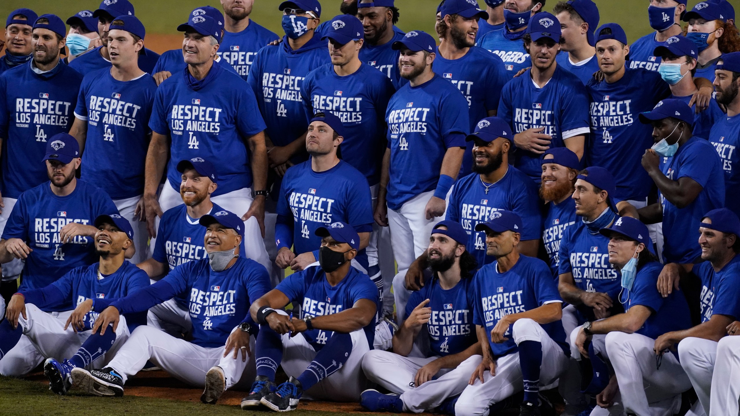 The Los Angeles Dodgers pose for a photo after the Dodgers clinched the NL West title with a 7-2 win over the Oakland Athletics in a baseball game on Sept. 22, 2020, in Los Angeles. (AP Photo/Ashley Landis)